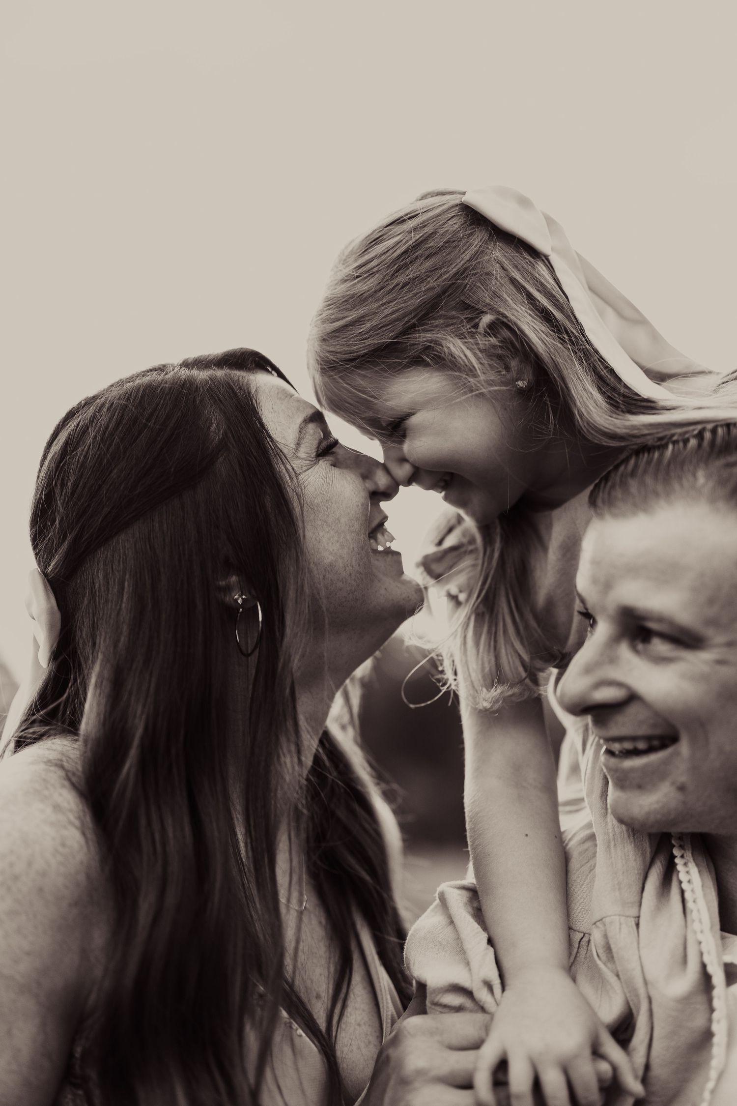 Intimate family moment captured in black and white portrait.