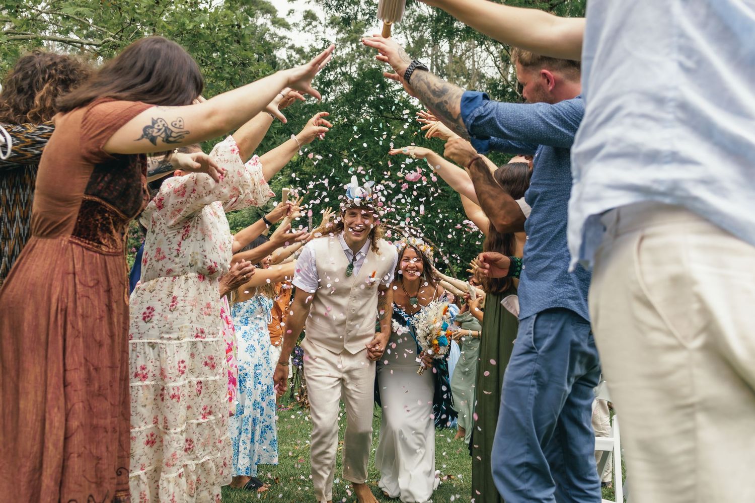 Guests at a wedding cheer on the bride and groom