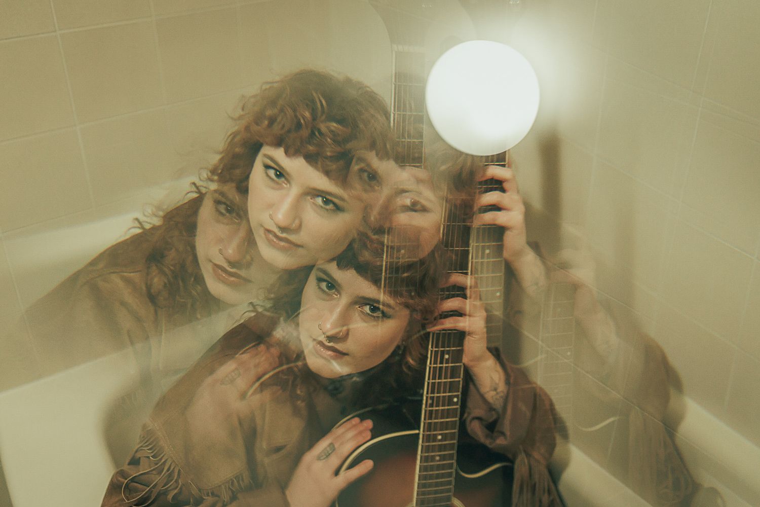 Vintage-style portrait with guitar and round lamp creating atmospheric lighting effect.