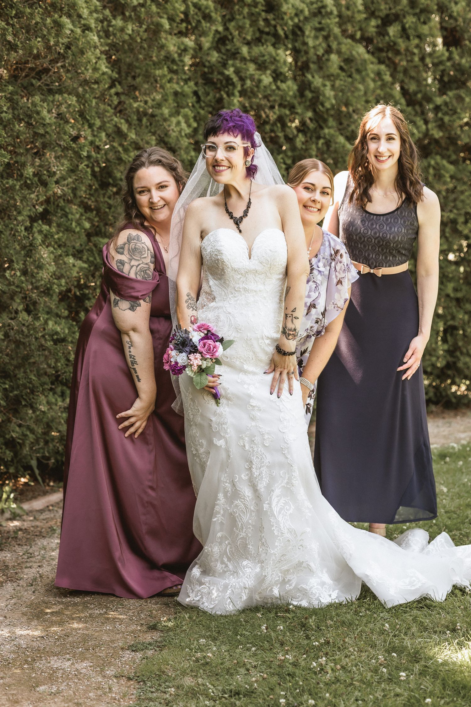 A bride and her bridesmaids posing in the park