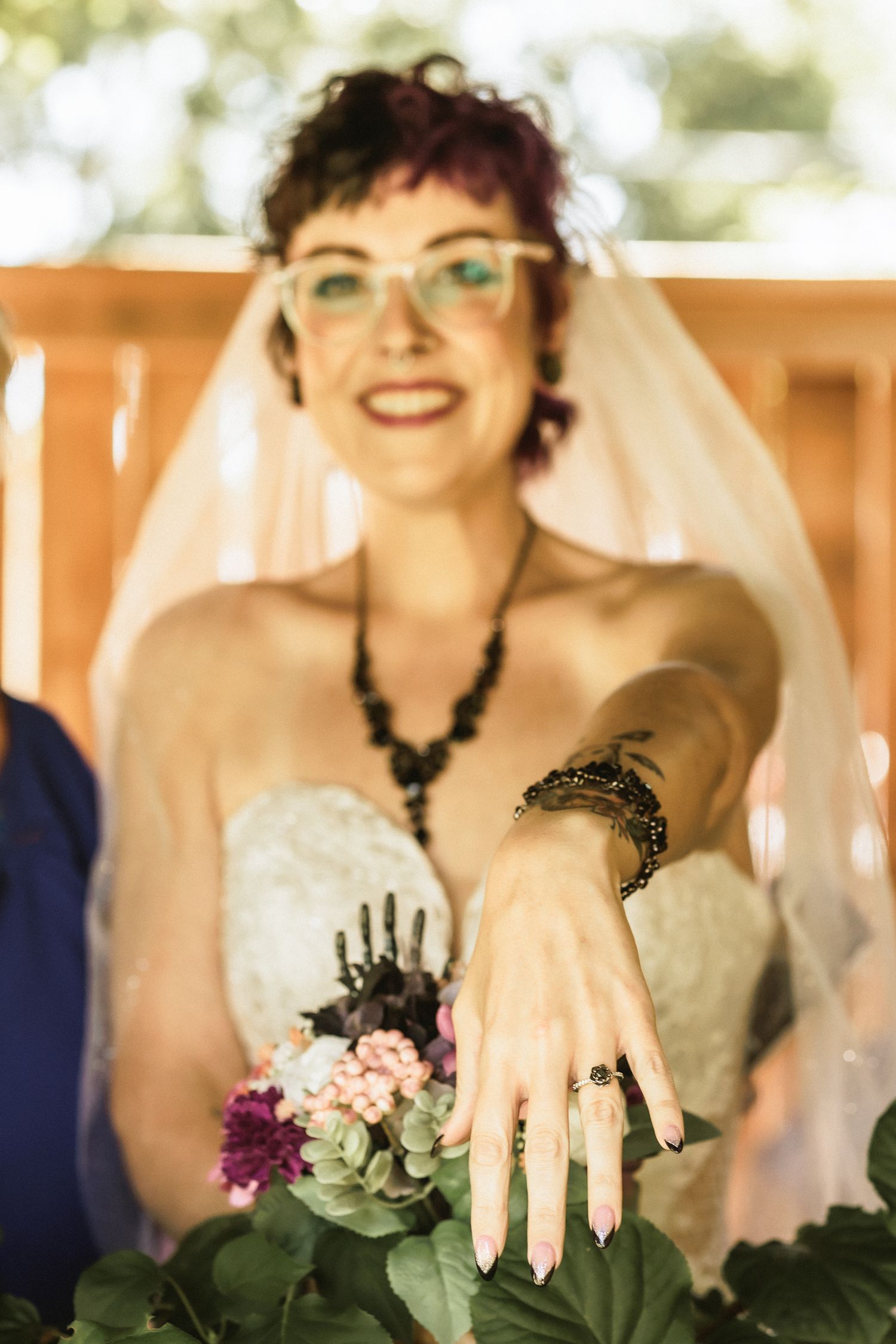 a bride showing her ring and bouquet