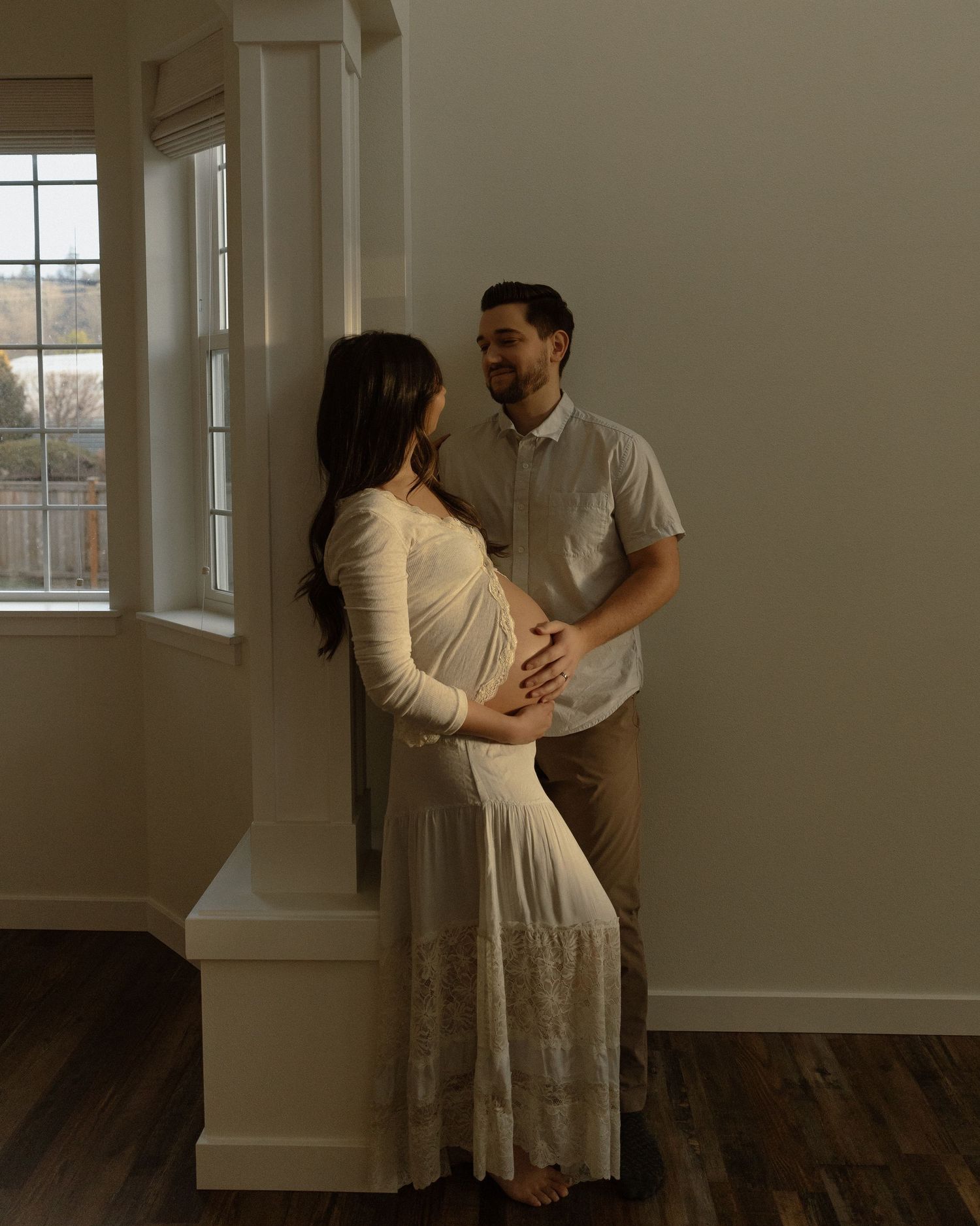 A loving couple sharing a tender moment during their maternity photoshoot.