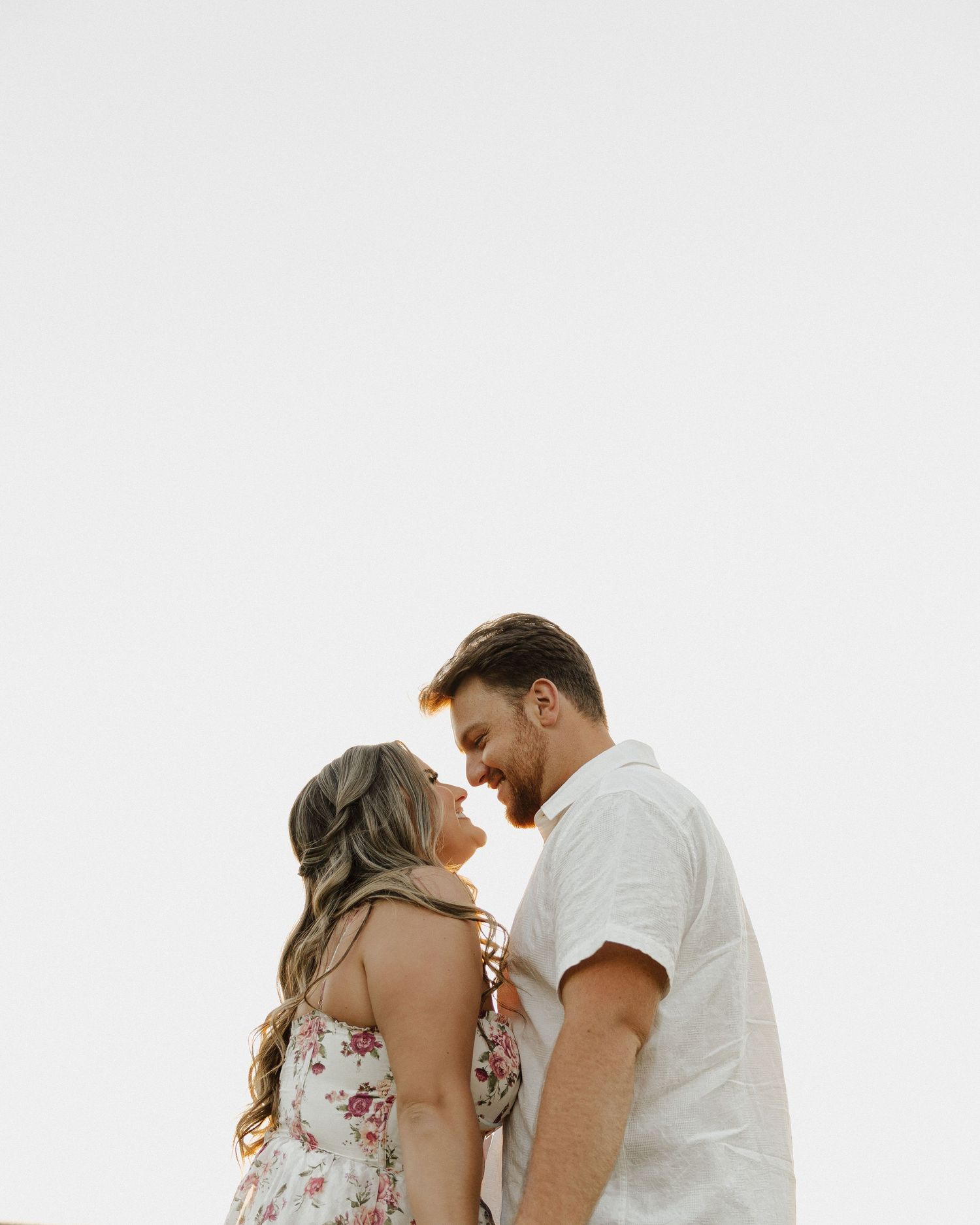Close-up of couple sharing intimate moment against white background.