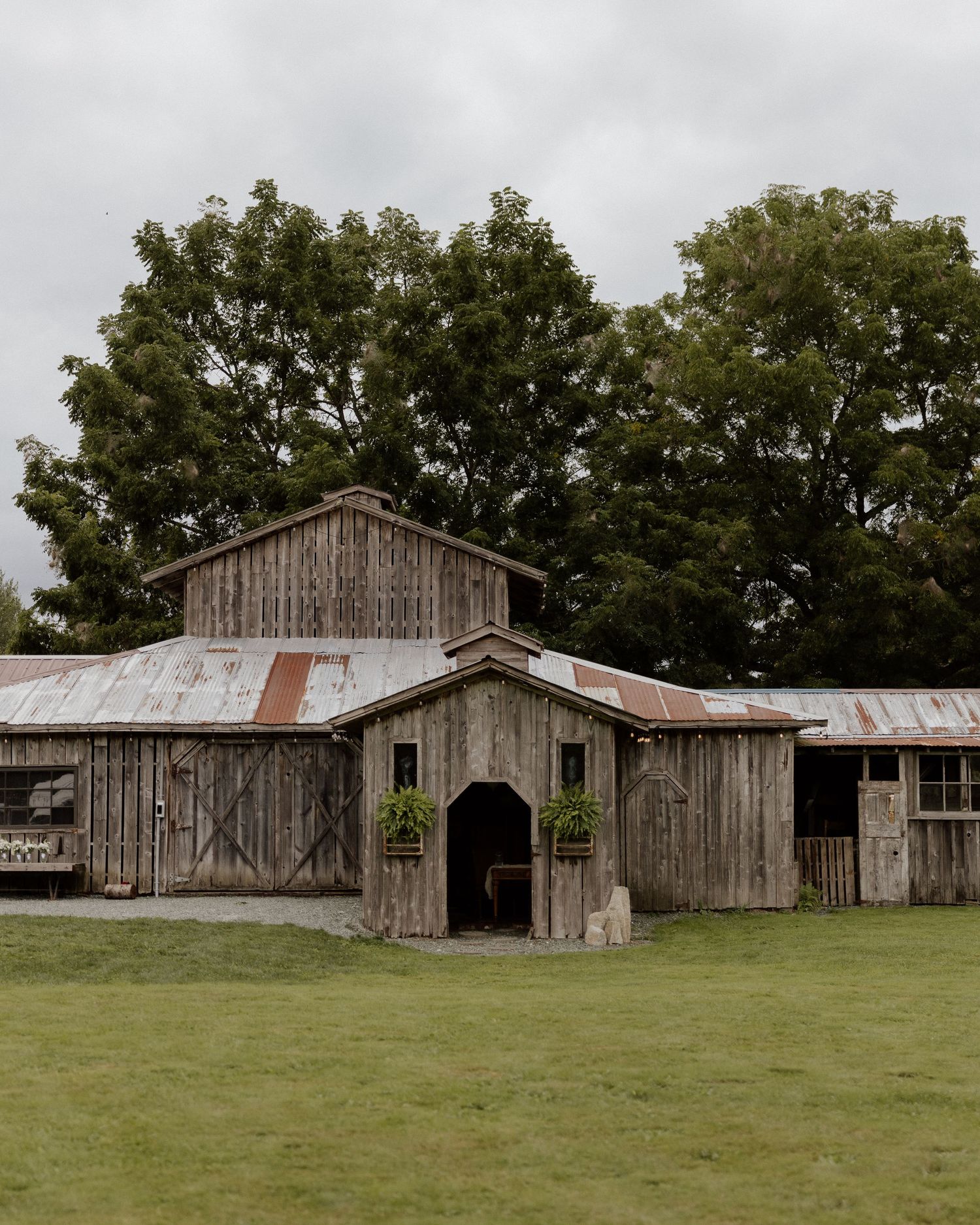 Rustic wooden barn with weathered siding and metal roof in rural setting.