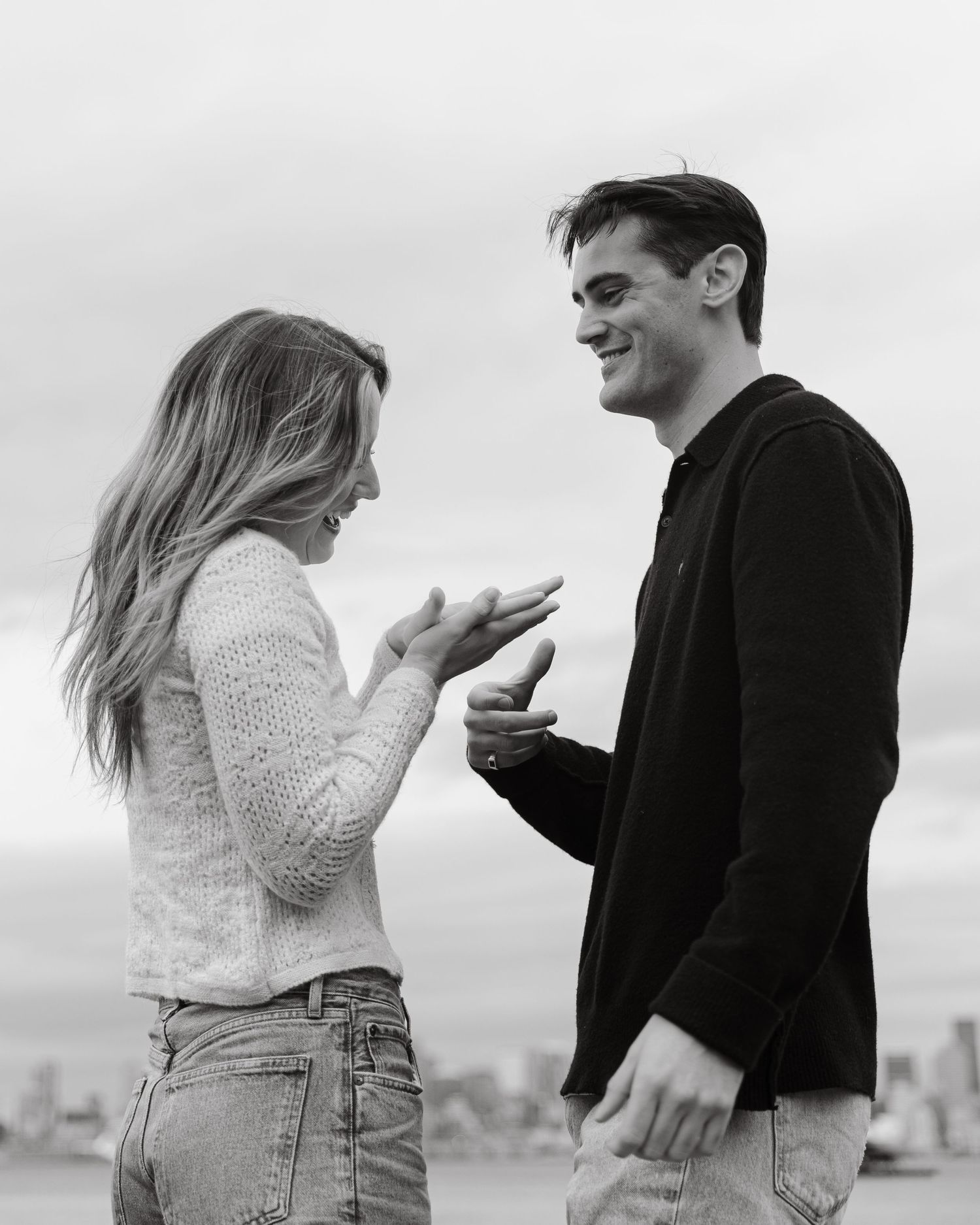 A couple engaged in animated conversation while standing on a scenic overlook.