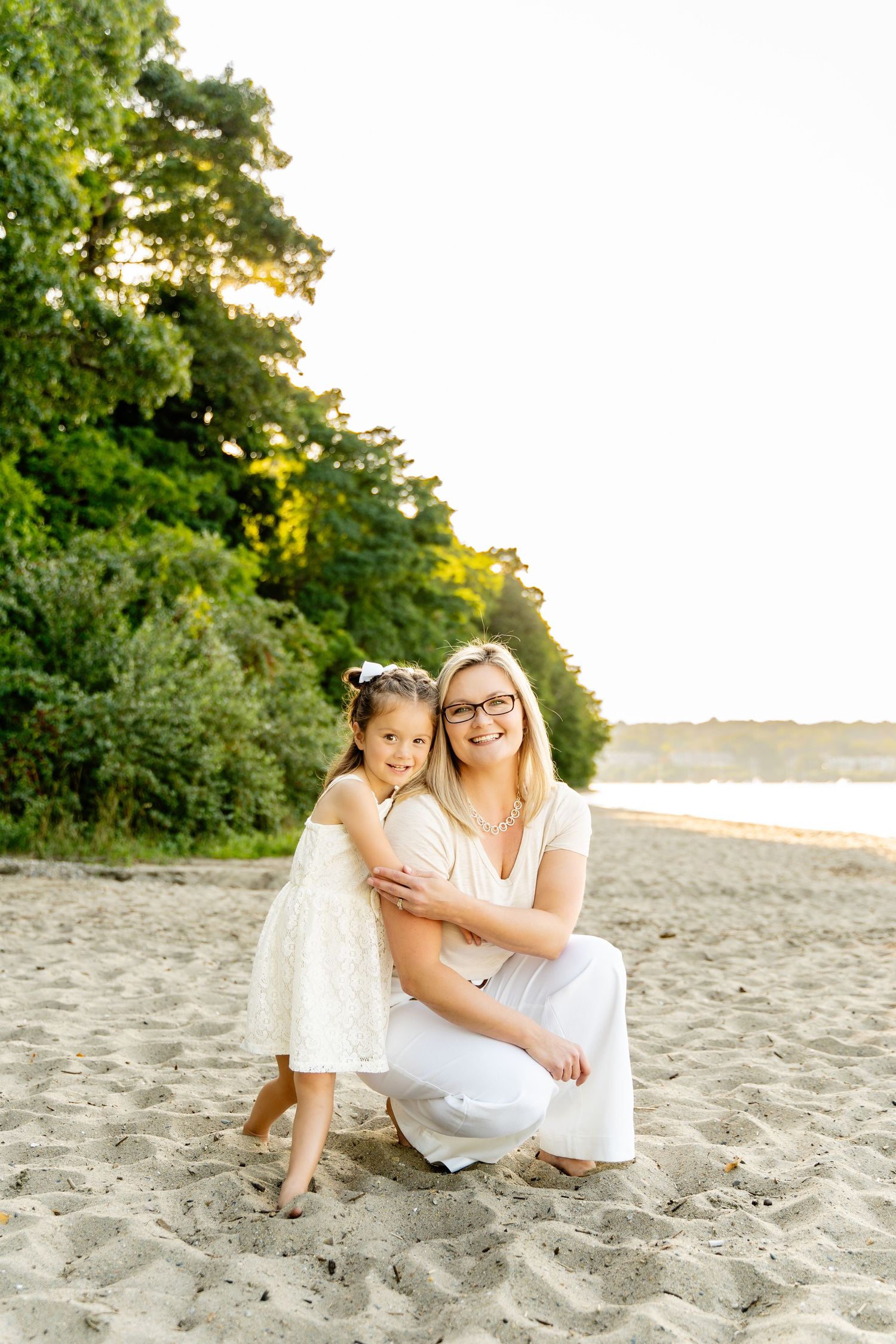 Intimate beach portrait with lush green foliage background at golden hour.