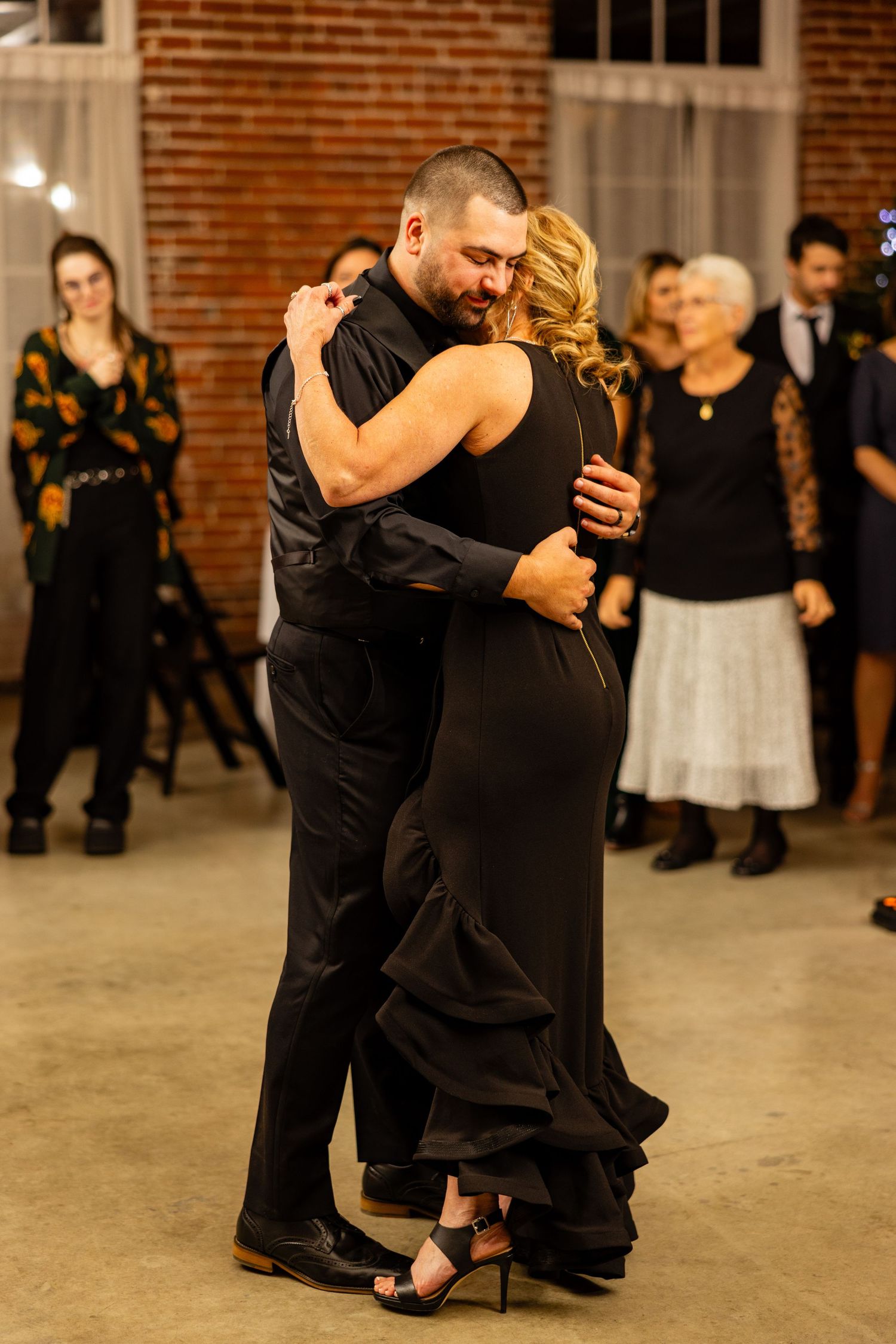 Couple embracing during an intimate dance moment at their wedding reception.