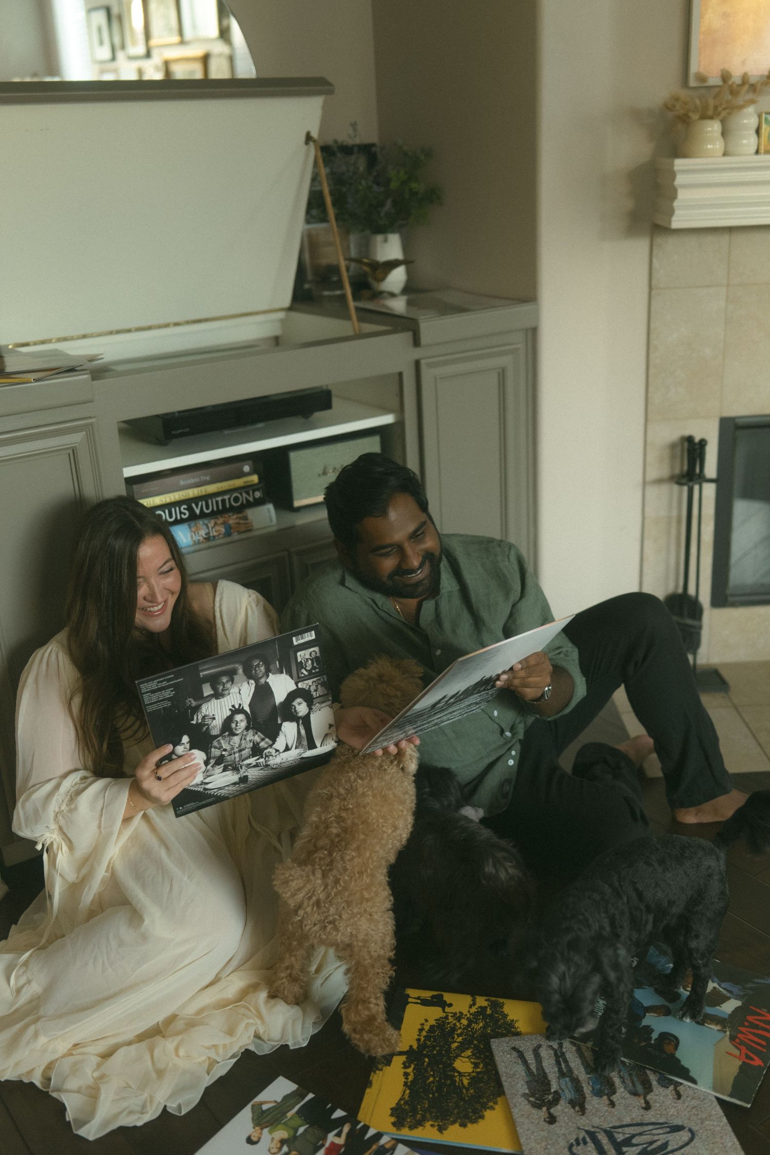 Two people lounging on a couch looking at photos together.