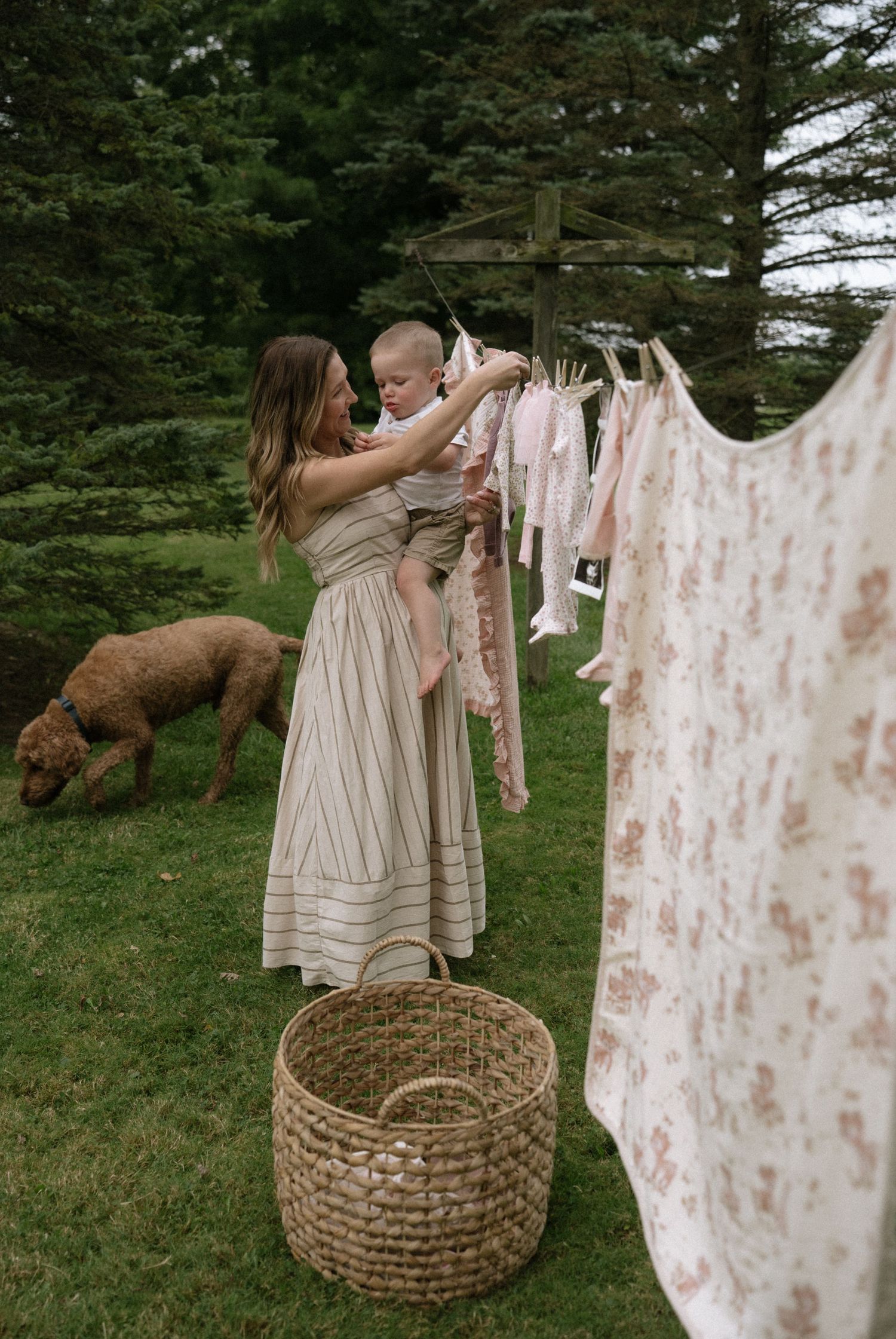 Vintage-style laundry hanging on clotheslines outdoors with wicker baskets below.