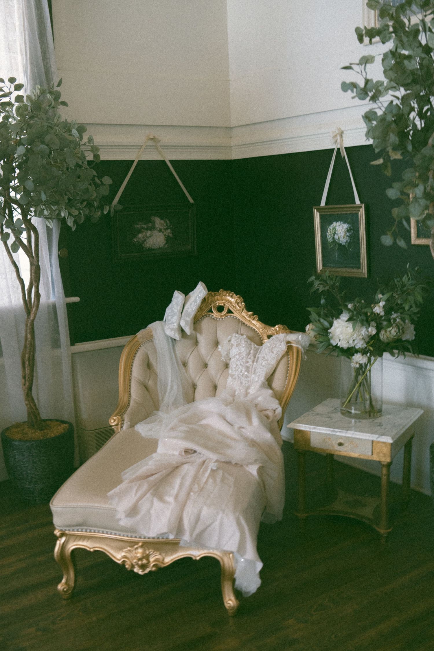 Ornate white chaise lounge in a vintage-style room with natural lighting.