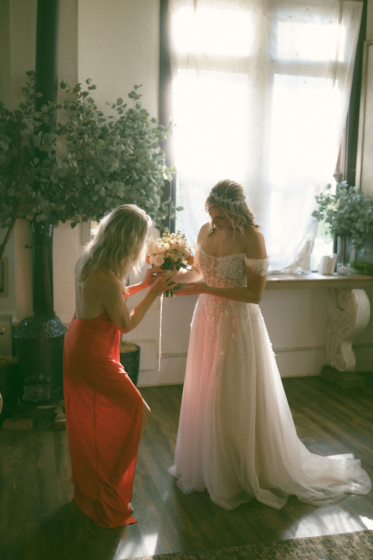 Wedding dress preparations in a sunlit room with natural decor.