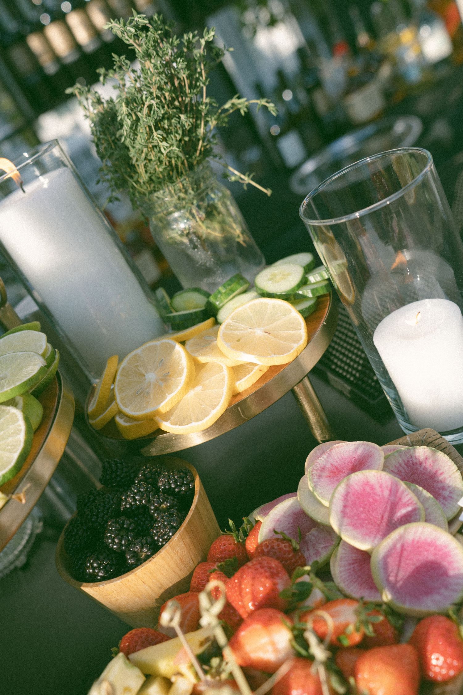 Elegant table decor with citrus slices, orchids, and candles for a wedding reception.