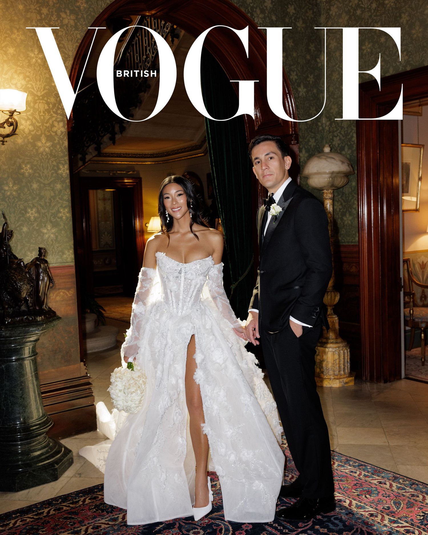 British Vogue cover with bride in lace ballgown and groom in tuxedo in grand interior.