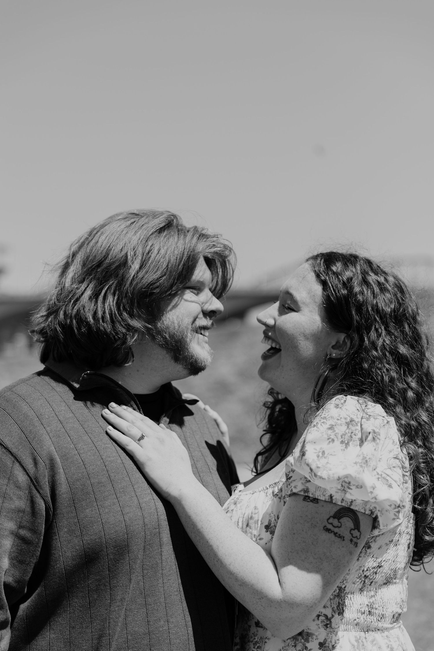 A black and white portrait capturing a tender moment between two people.