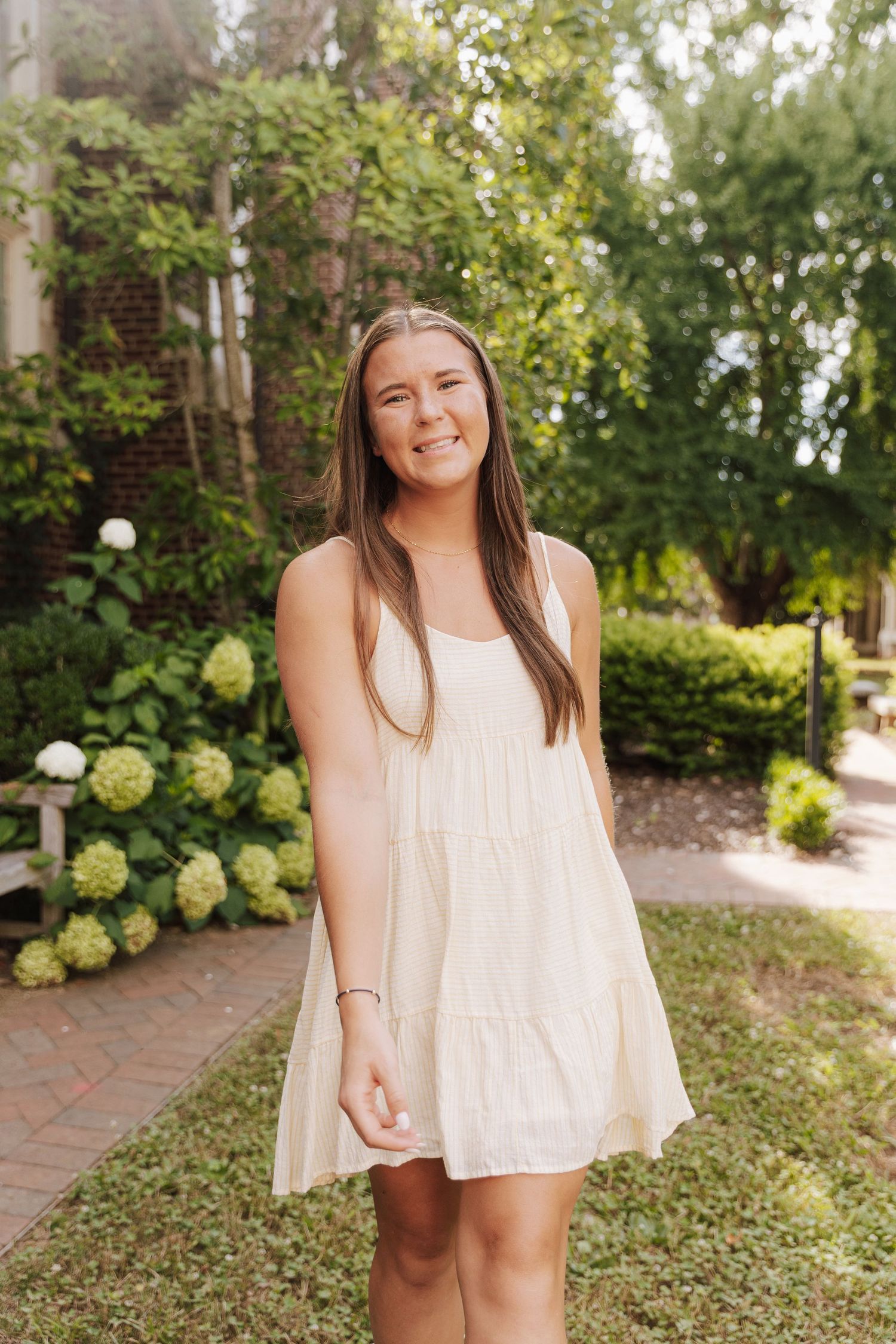 A sequence of outdoor portrait photos in a garden setting with someone wearing a white summer dress.