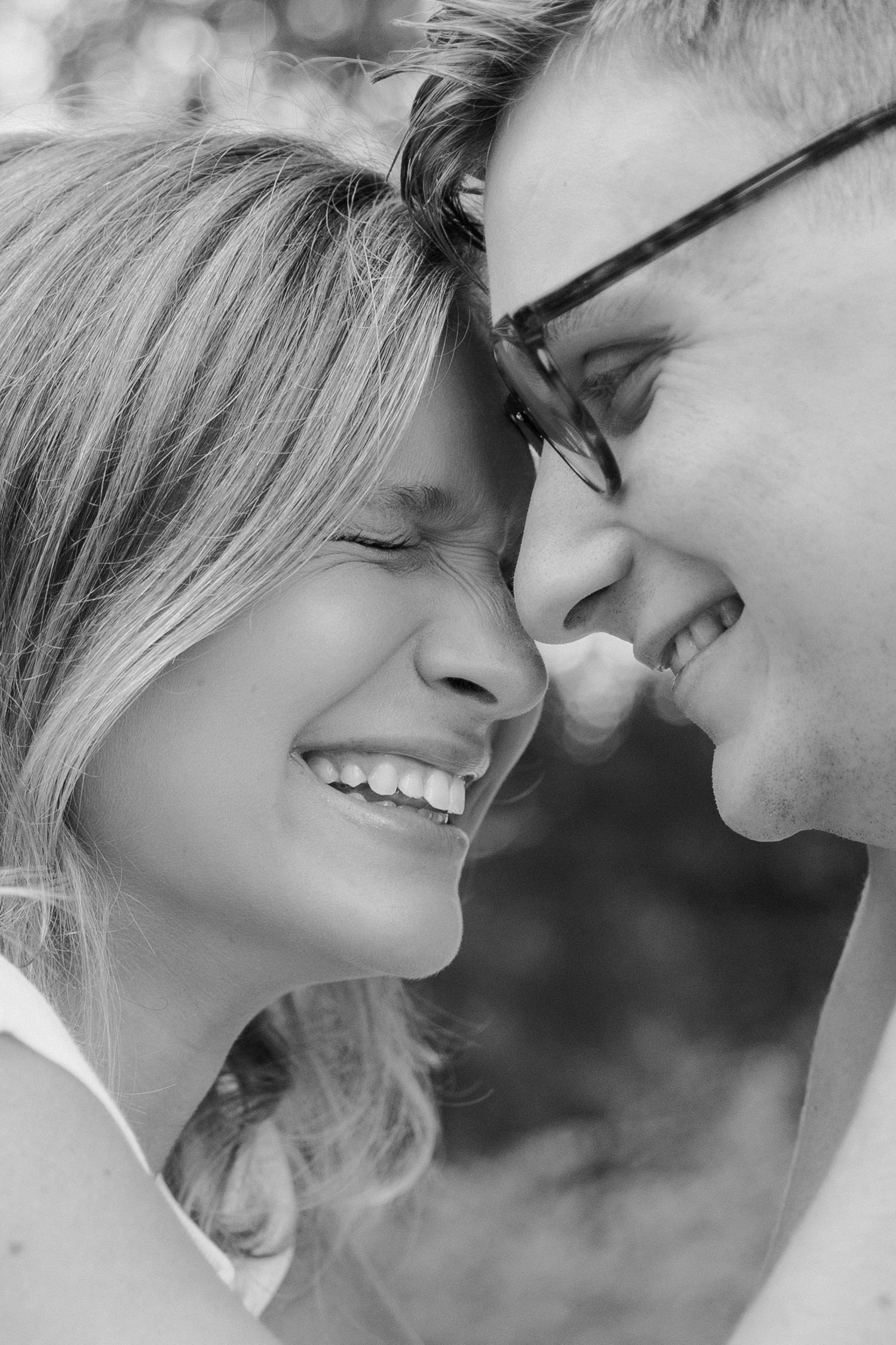 Close-up black and white portrait of a romantic couple sharing an intimate moment.