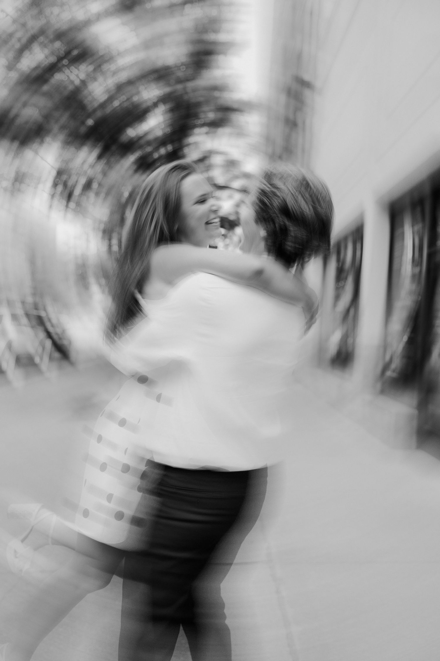 Abstract black and white motion blur photograph showing spinning movement and circular patterns.