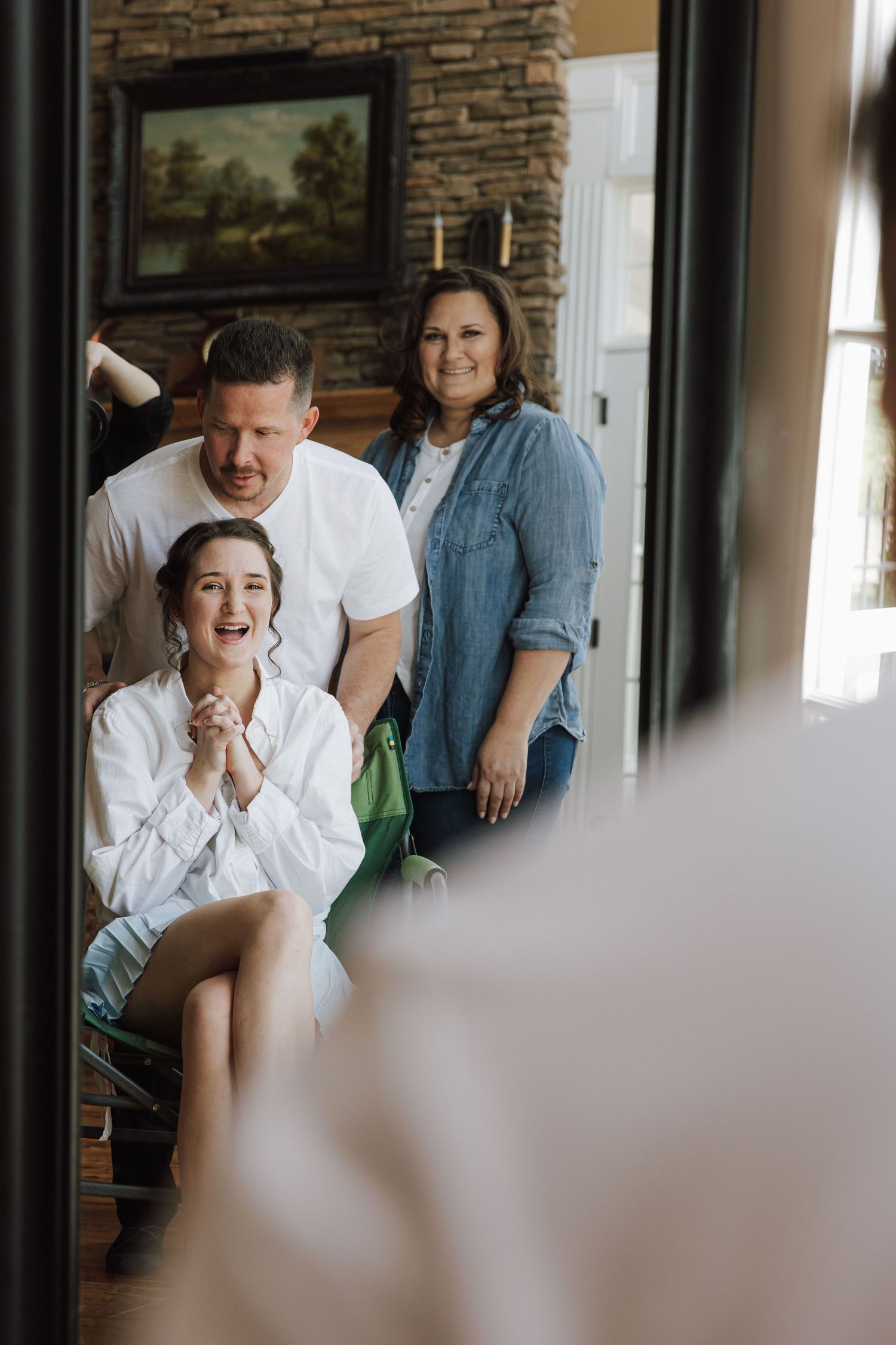 Candid moments captured during wedding preparations in an indoor venue with brick walls.