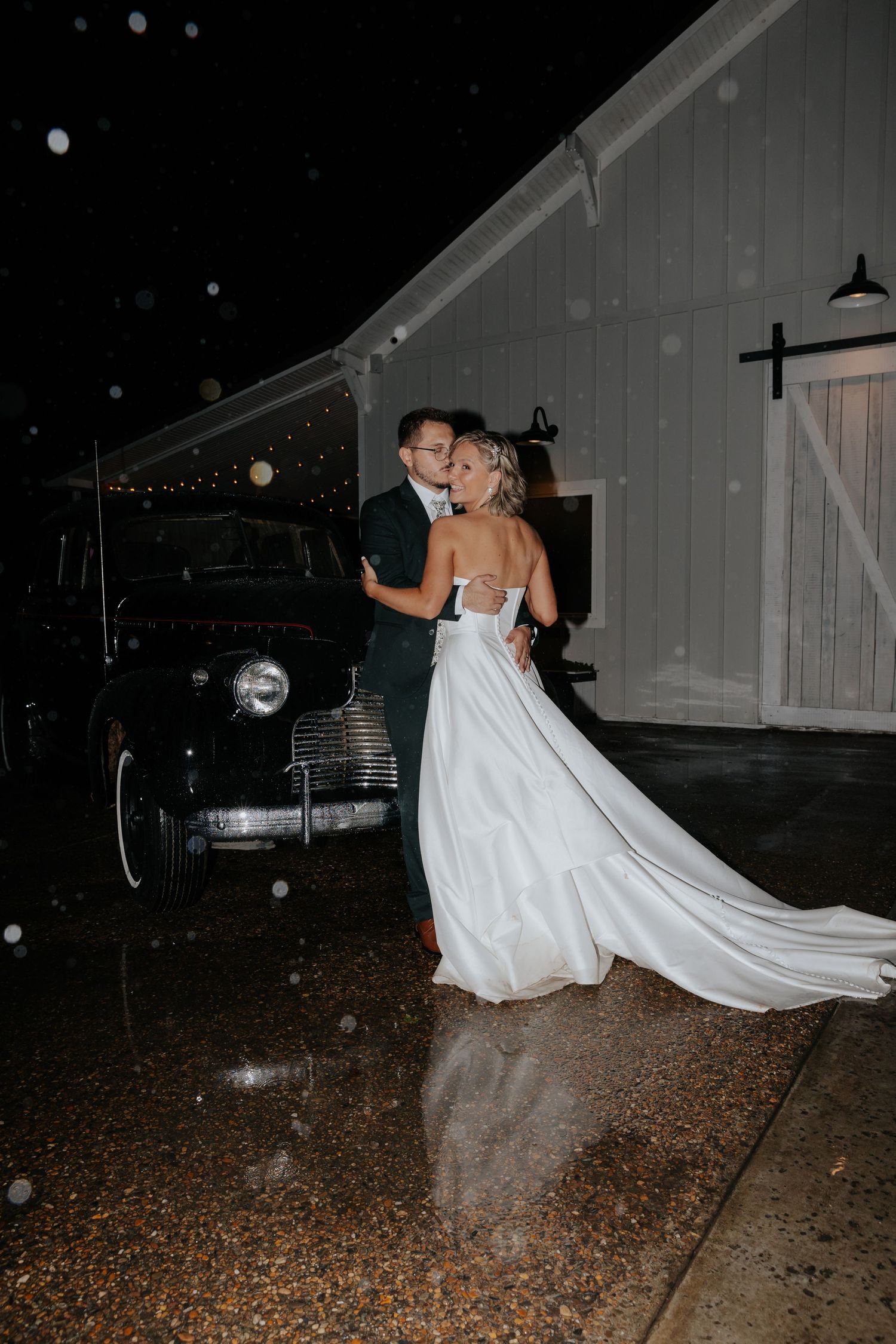 Nighttime wedding photos showing couple dancing outside with flowing dress movement.