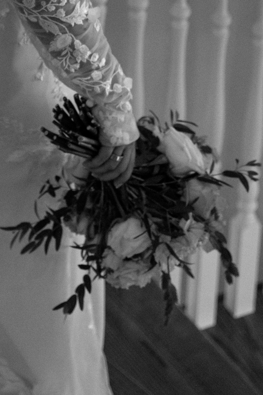 Black and white artistic photo of wedding bouquet with dramatic shadows.