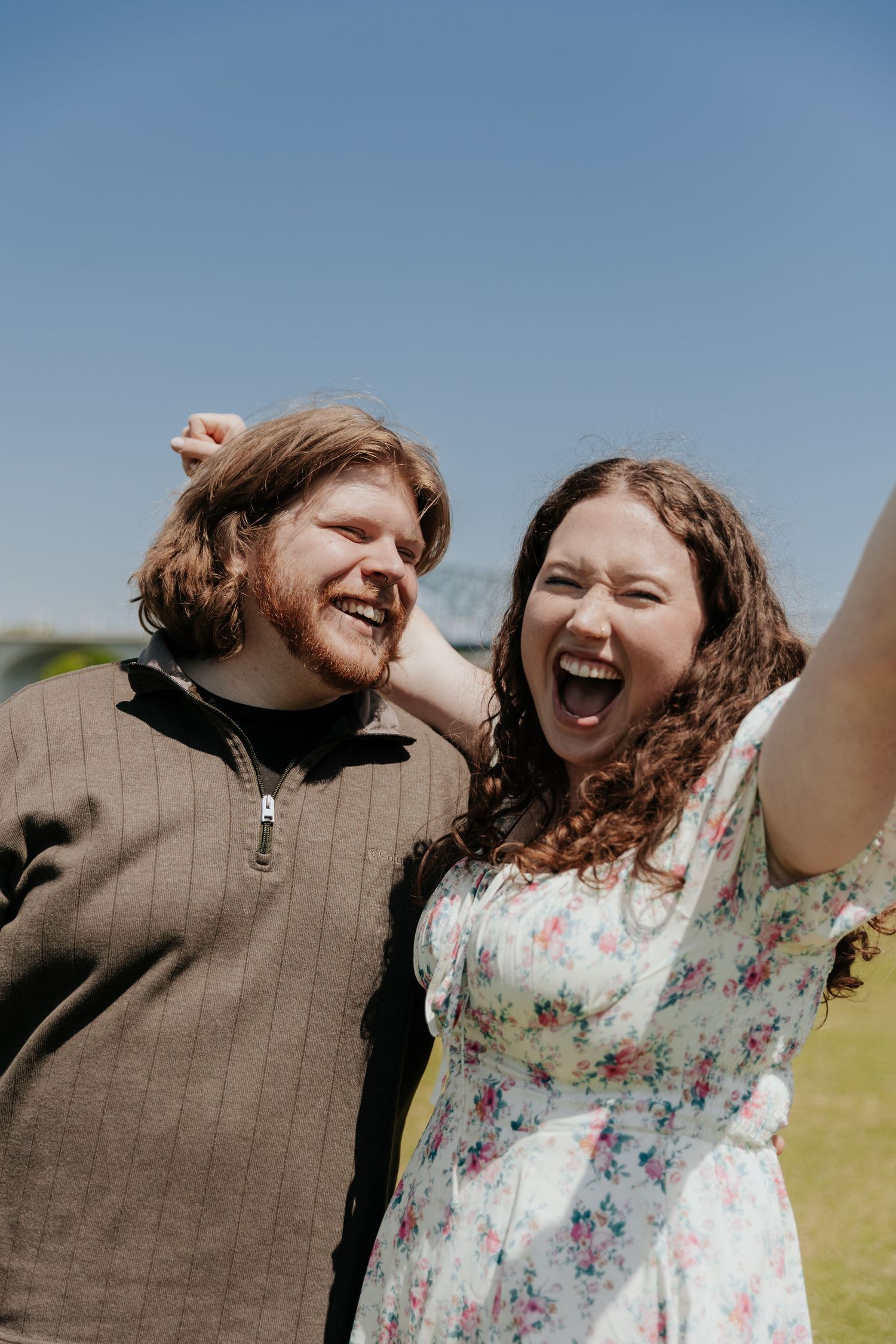 A candid moment of pure joy and laughter shared between a couple outdoors.