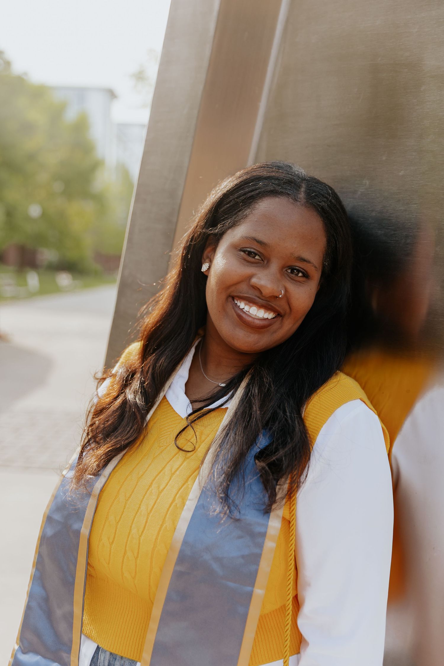 A series of four similar photos showing someone in a bright yellow top smiling against a blurred background.