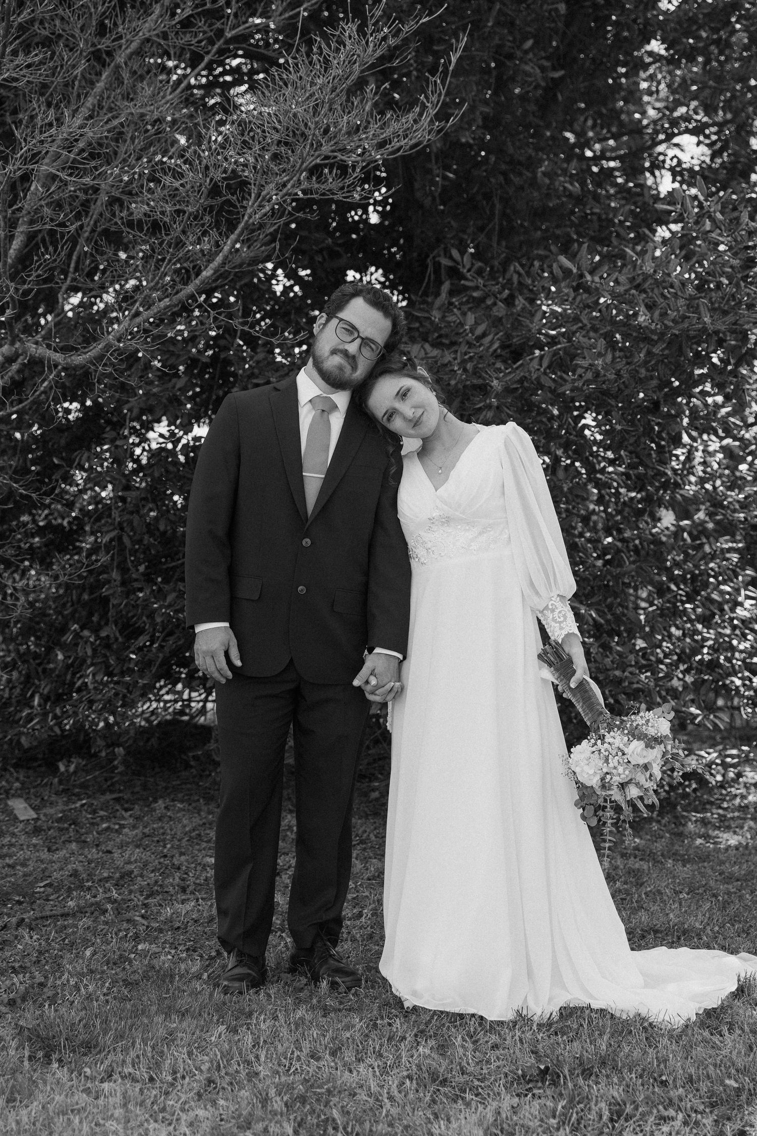 Romantic black and white wedding portraits captured in a natural outdoor setting.