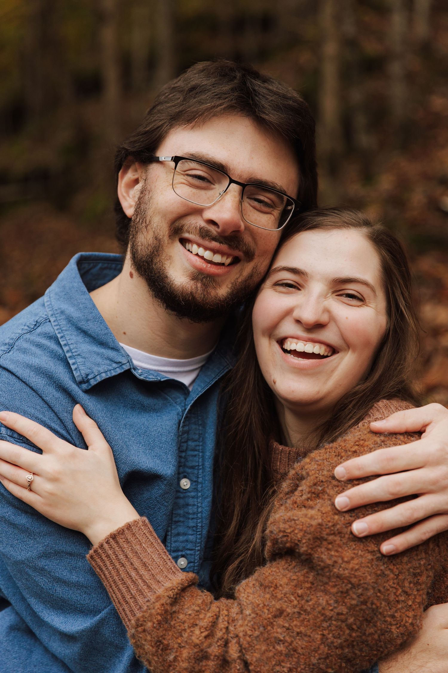 A couple wearing blue denim and brown sweater share intimate candid moments in a series of romantic outdoor photos.