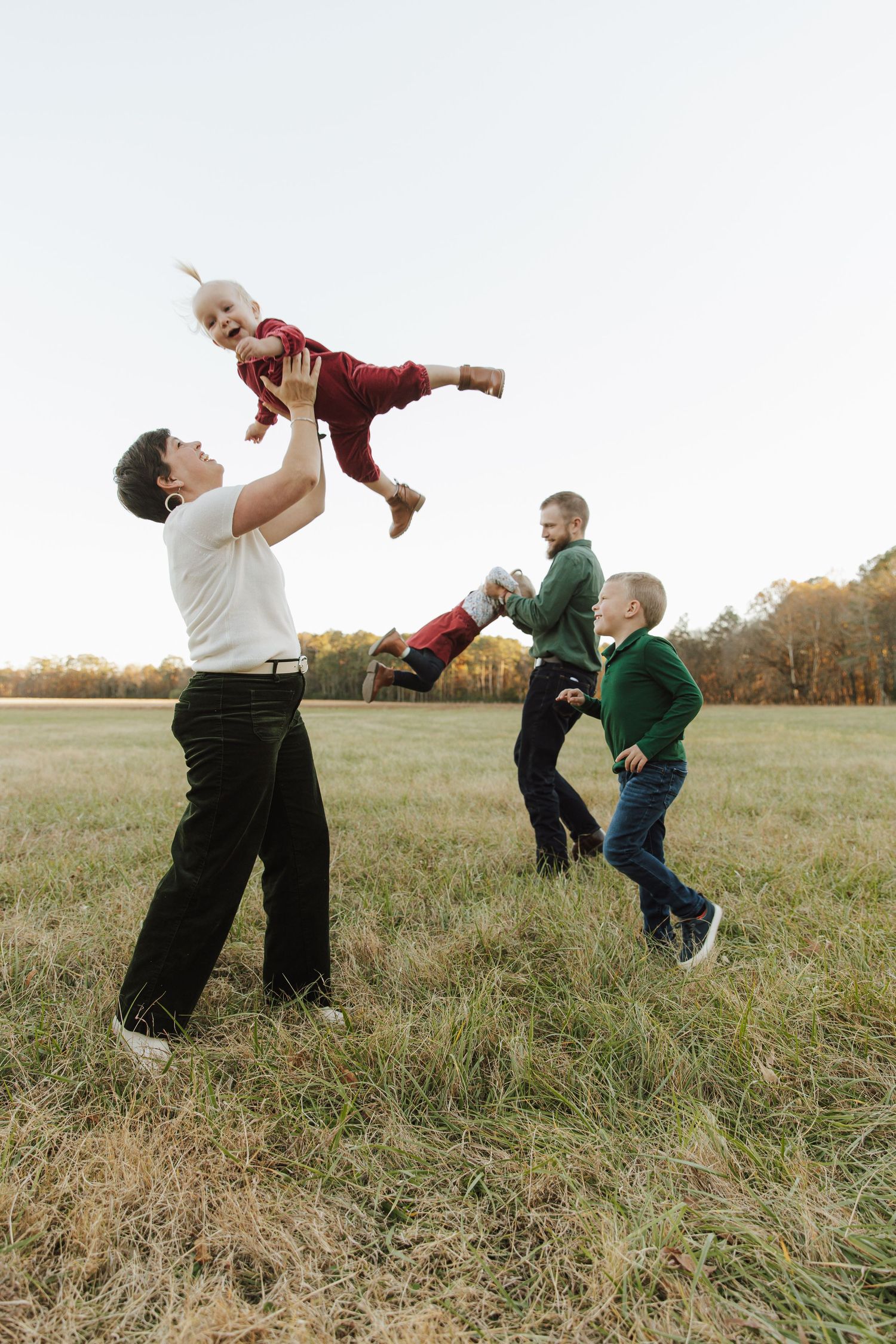A playful sequence shows two people in a grassy field performing acrobatic movements together.