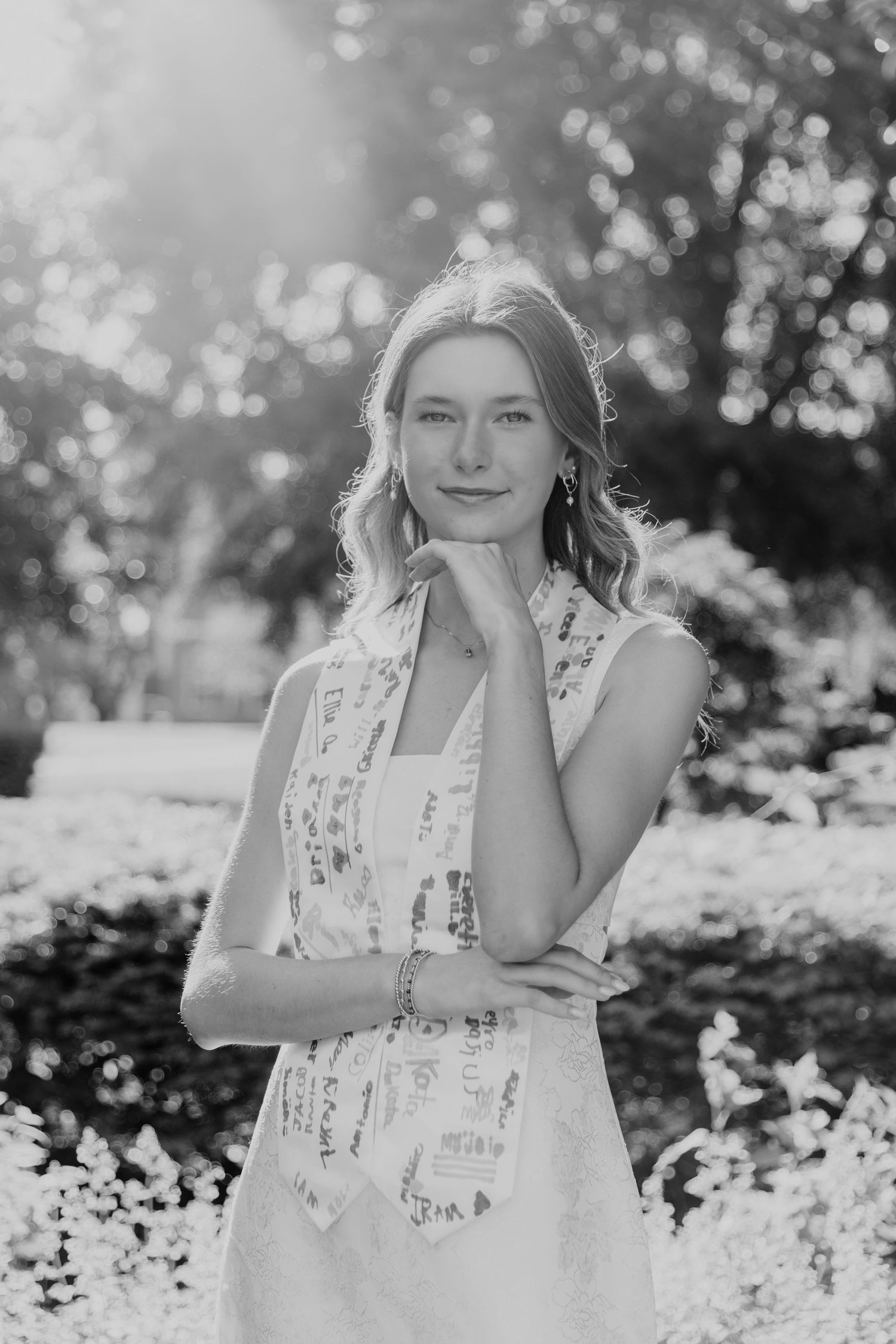 Black and white portrait series with bokeh lighting effects in a natural outdoor setting.