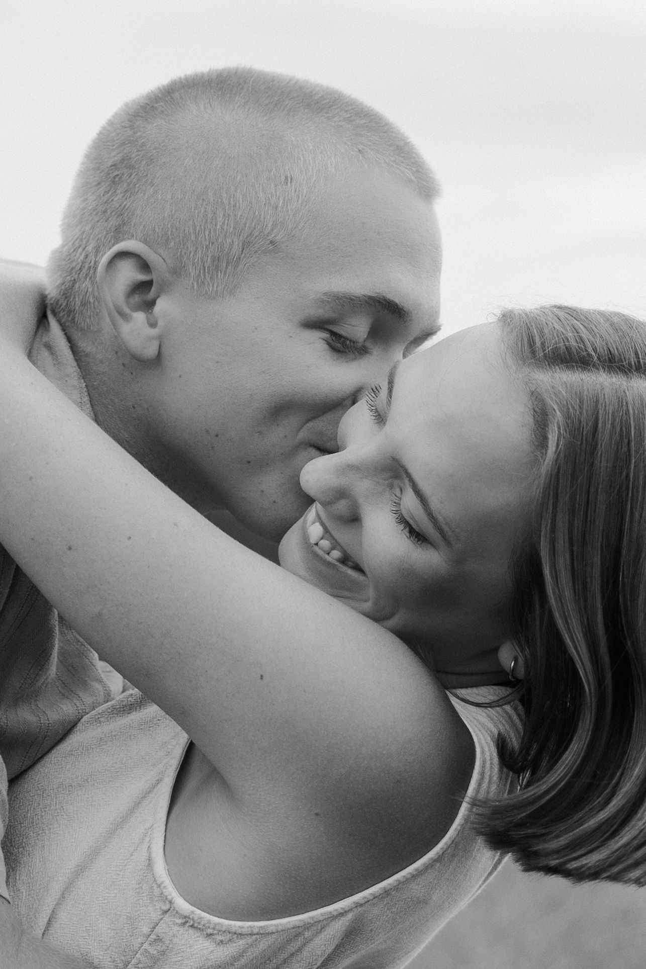 A romantic black and white photo sequence showing a couple sharing an intimate kiss from different angles.