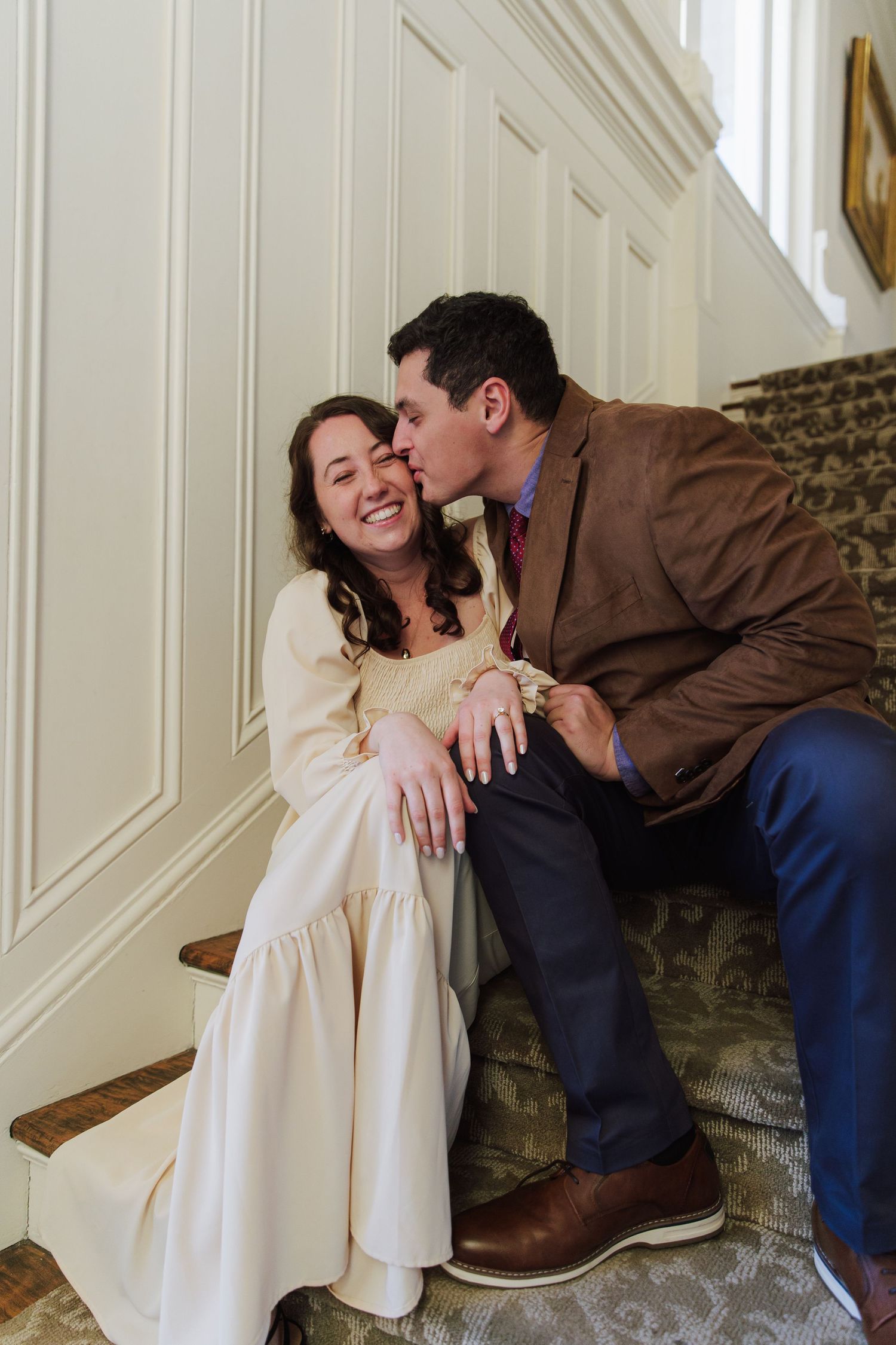 A romantic couple shares intimate moments in a series of candid shots against a white paneled wall.