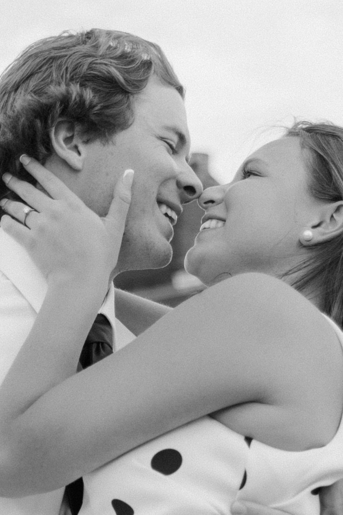 Black and white close-up of a couple sharing an intimate embrace.