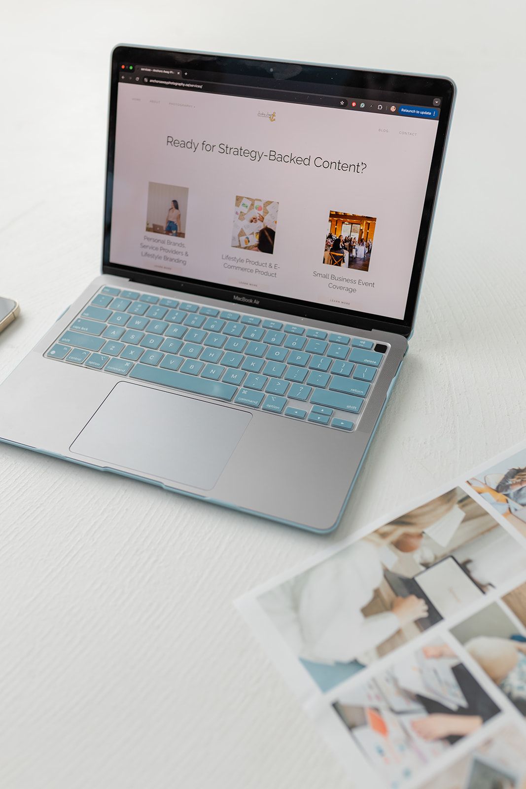 A laptop computer screen displaying a website with images and text.