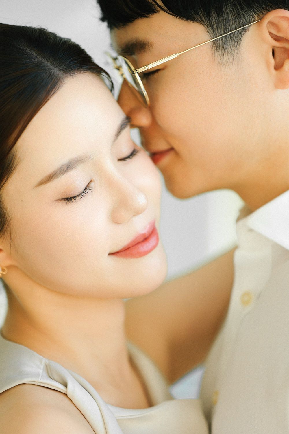 An intimate moment as the groom gently kisses the bride’s forehead while she smiles with eyes closed in timeless New York engagement style.