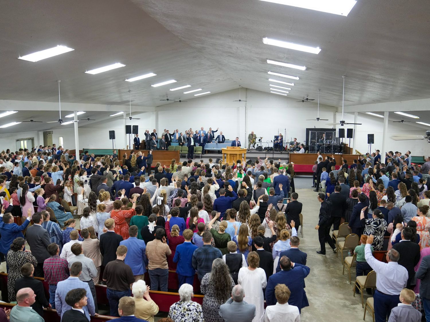 Large congregation gathered for worship in a spacious church hall.