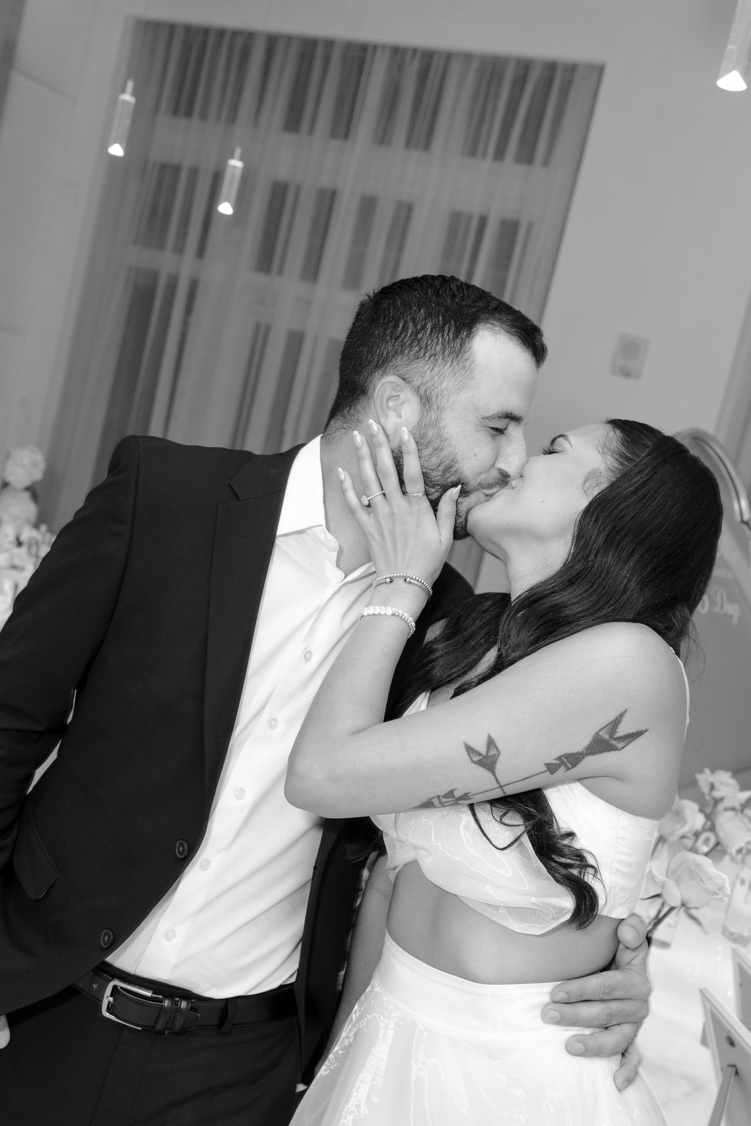 A romantic sequence of wedding photos shows a couple sharing their first kiss as newlyweds at their reception.