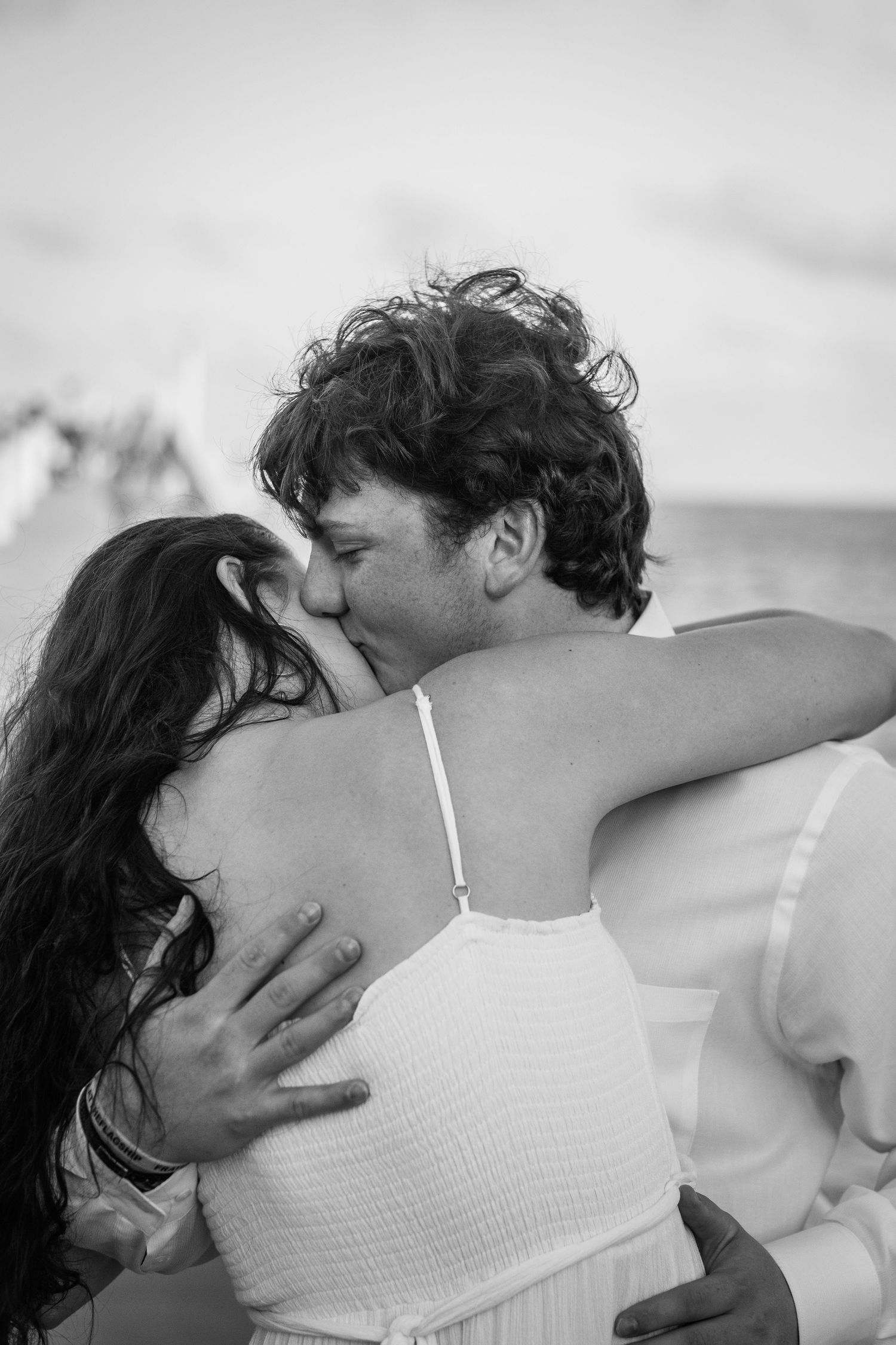 A romantic black and white photo series showing a couple embracing and kissing in intimate close-up shots.