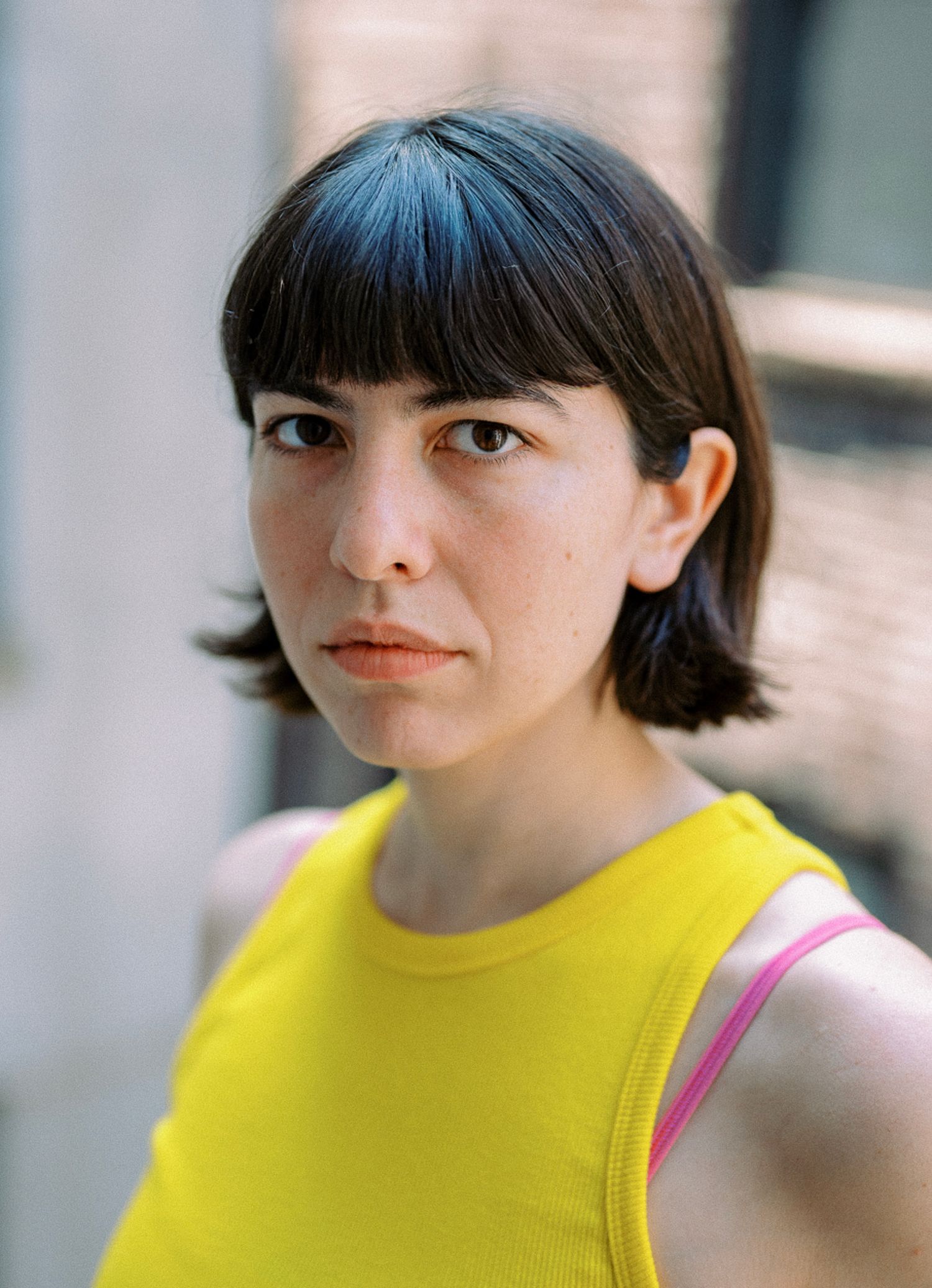A sequence of portrait photos showing someone in a yellow sleeveless top and bangs against a light background.