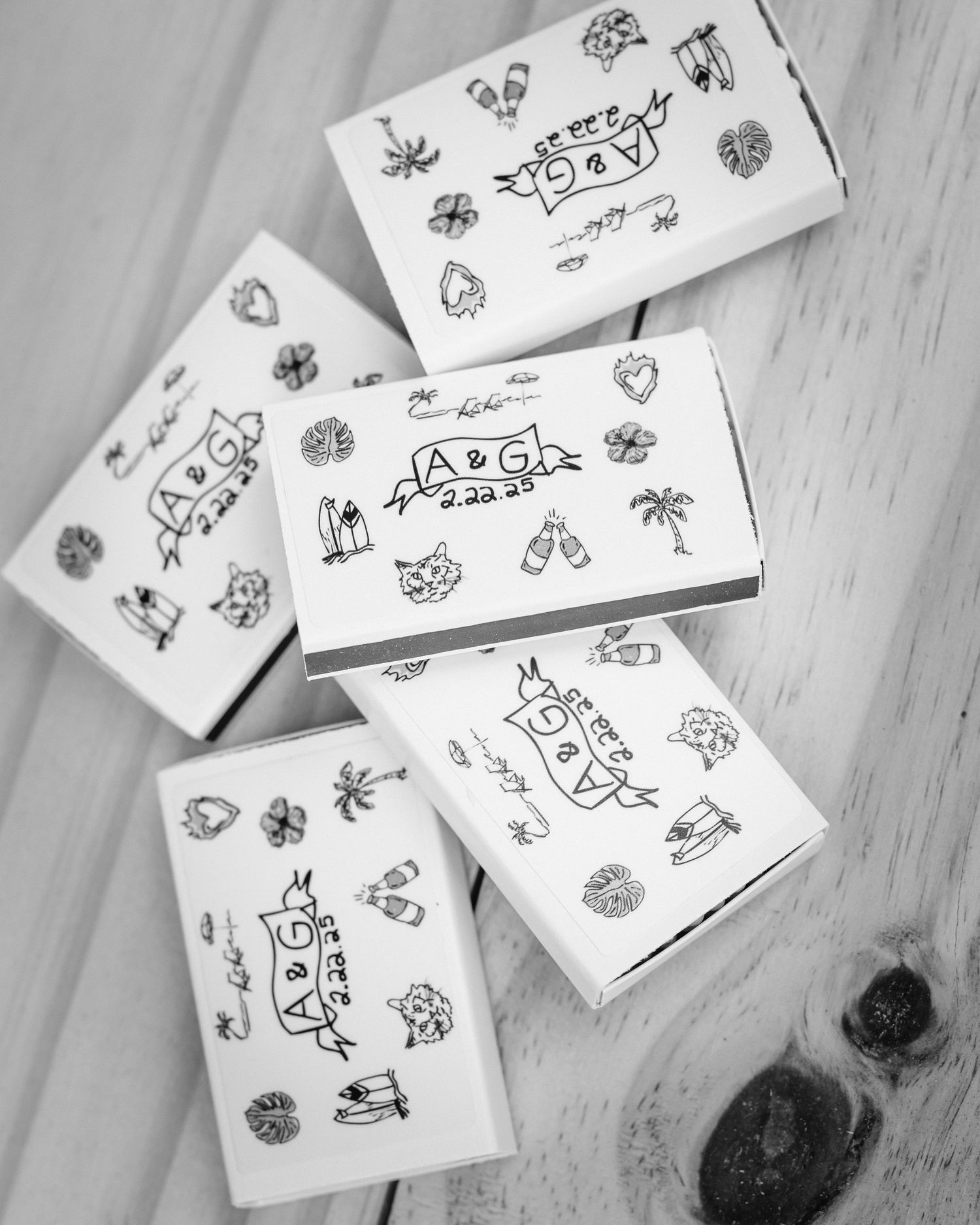 Black and white sketches of simple doodles and drawings scattered on a light wooden surface.
