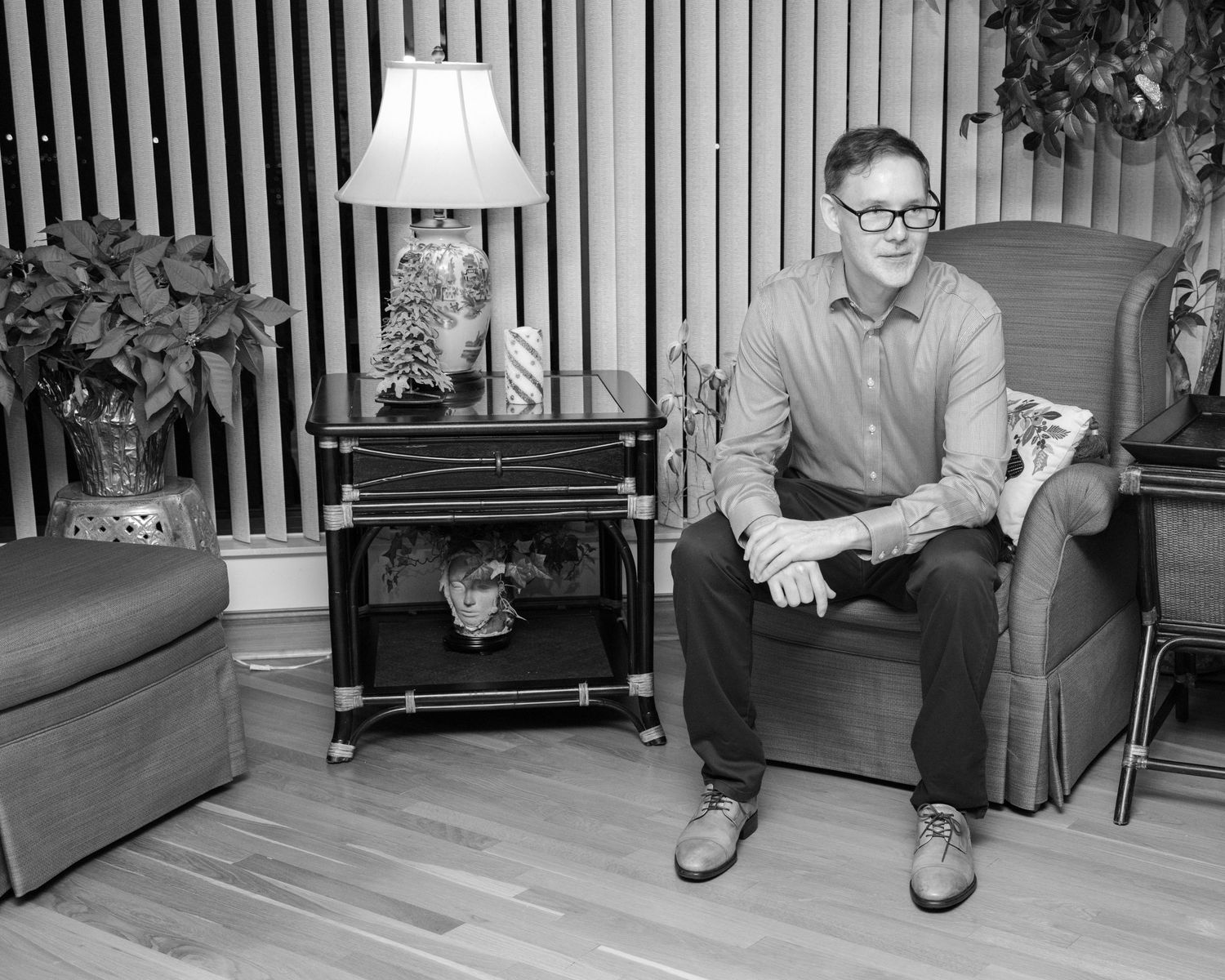 Series of black and white photographs showing people seated in a room with vertical striped walls.