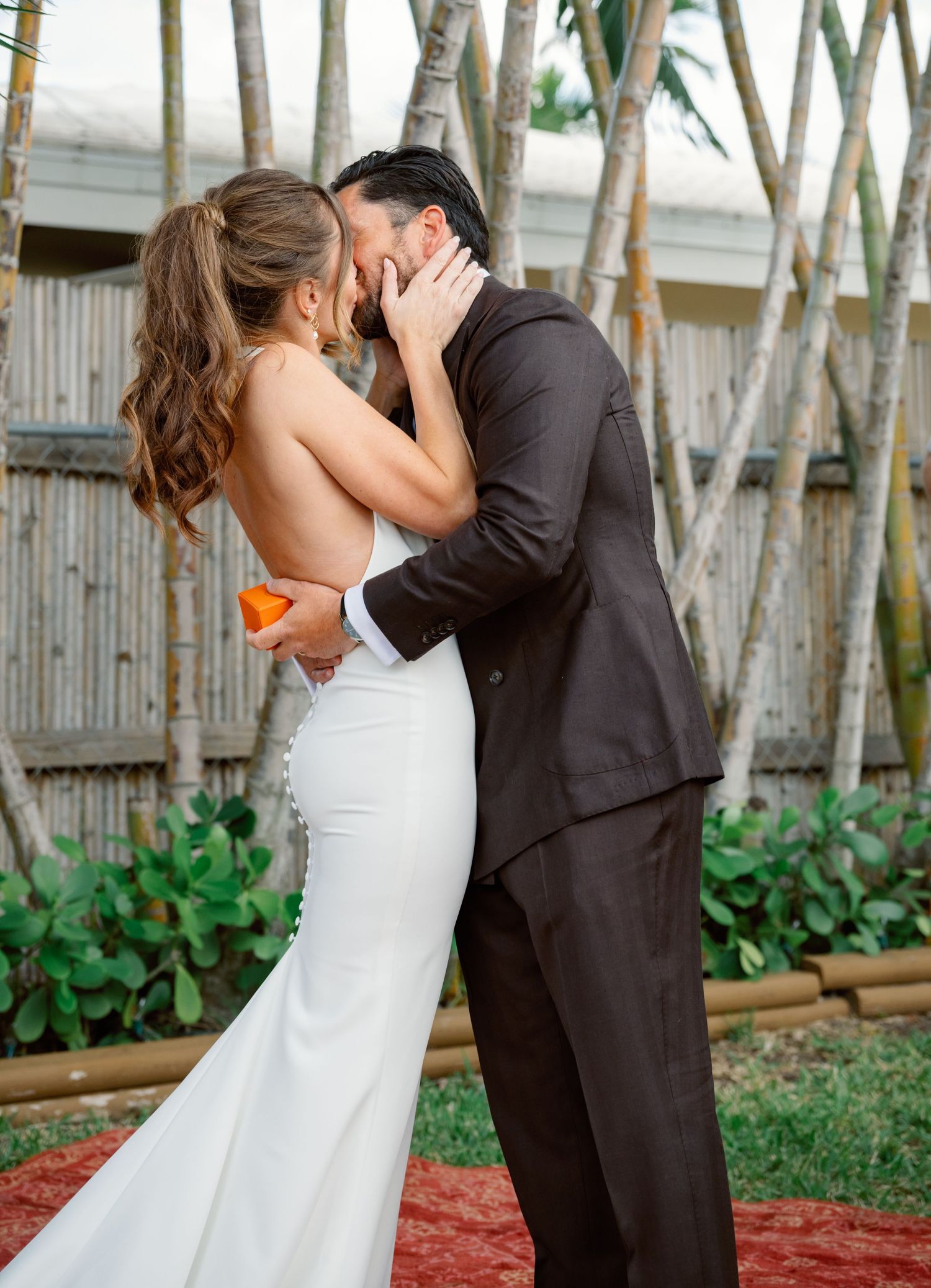 Romantic wedding couple sharing intimate moments in a garden setting with white birch trees.