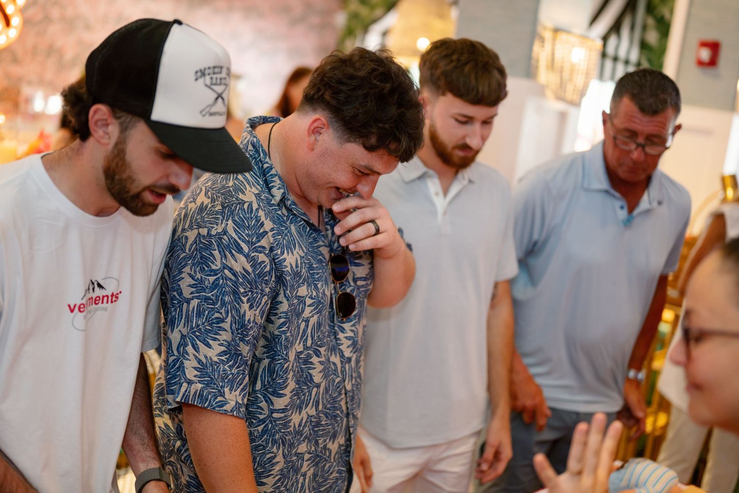 Group of people gathered at a social event with casual attire and festive atmosphere.