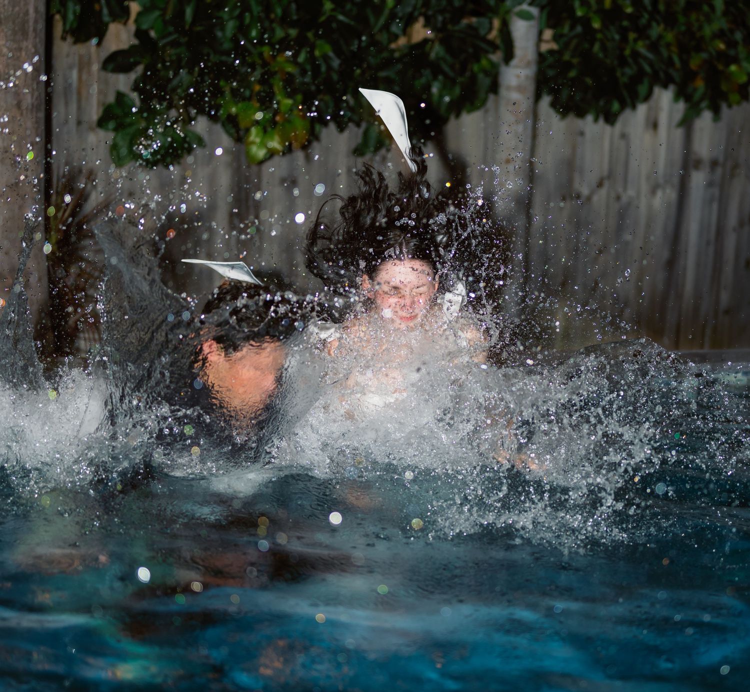 A sequence of splashing water droplets captured in a swimming pool creating dynamic patterns.