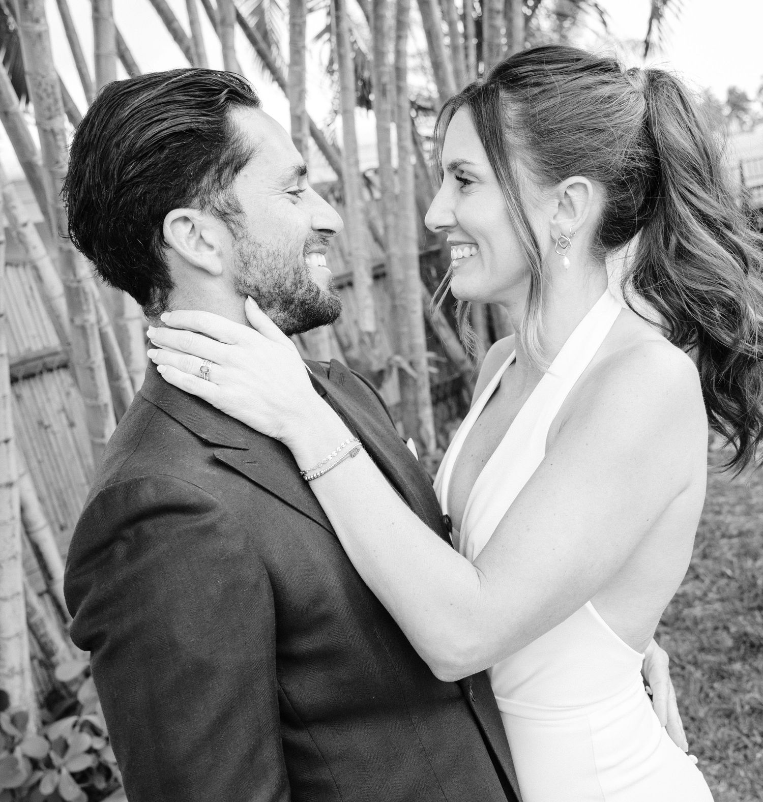 Black and white romantic wedding photos showing tender moments between a couple in formal attire.