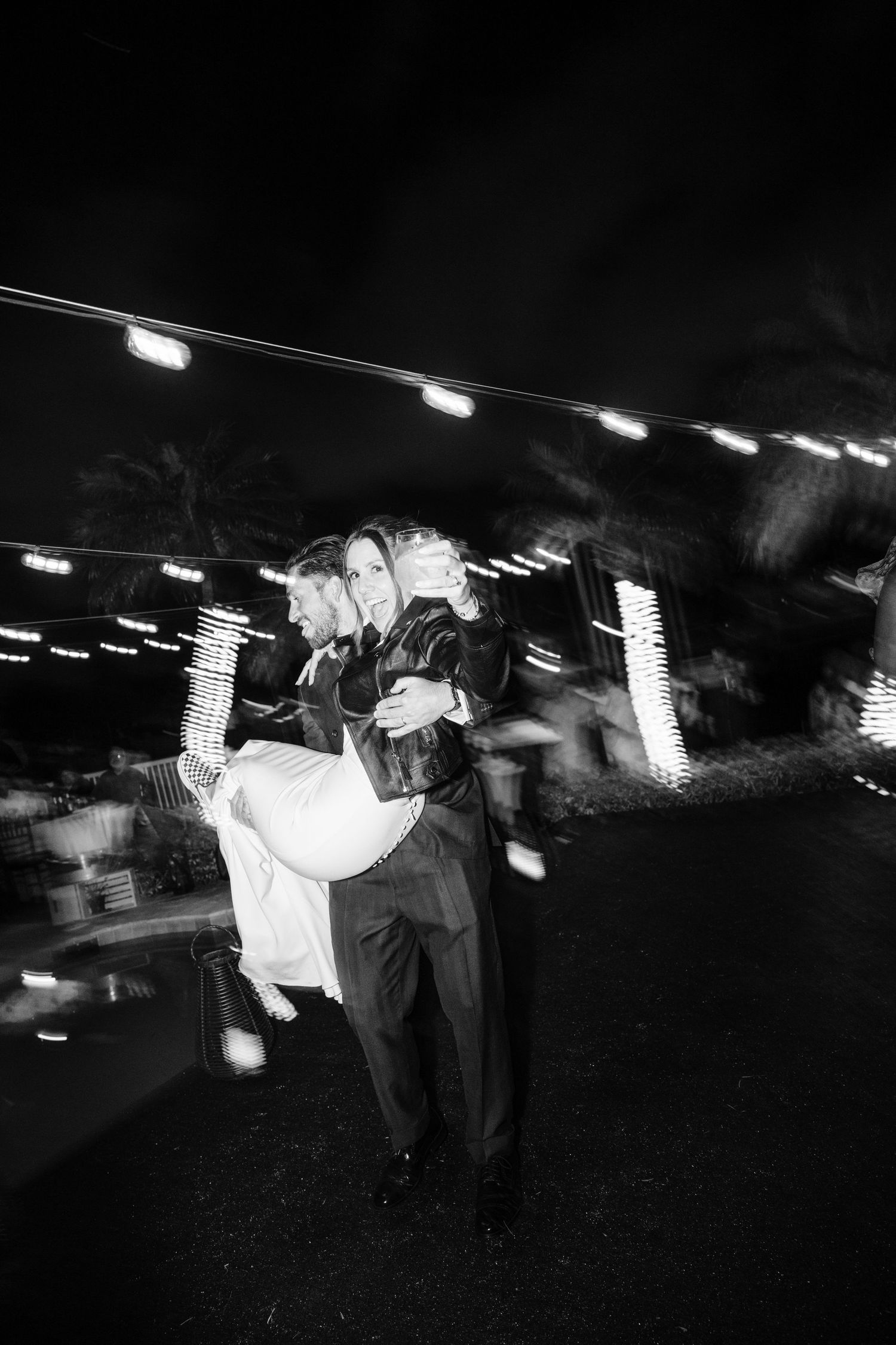 Black and white dance floor photo sequence showing a couple spinning and dancing under overhead lights.