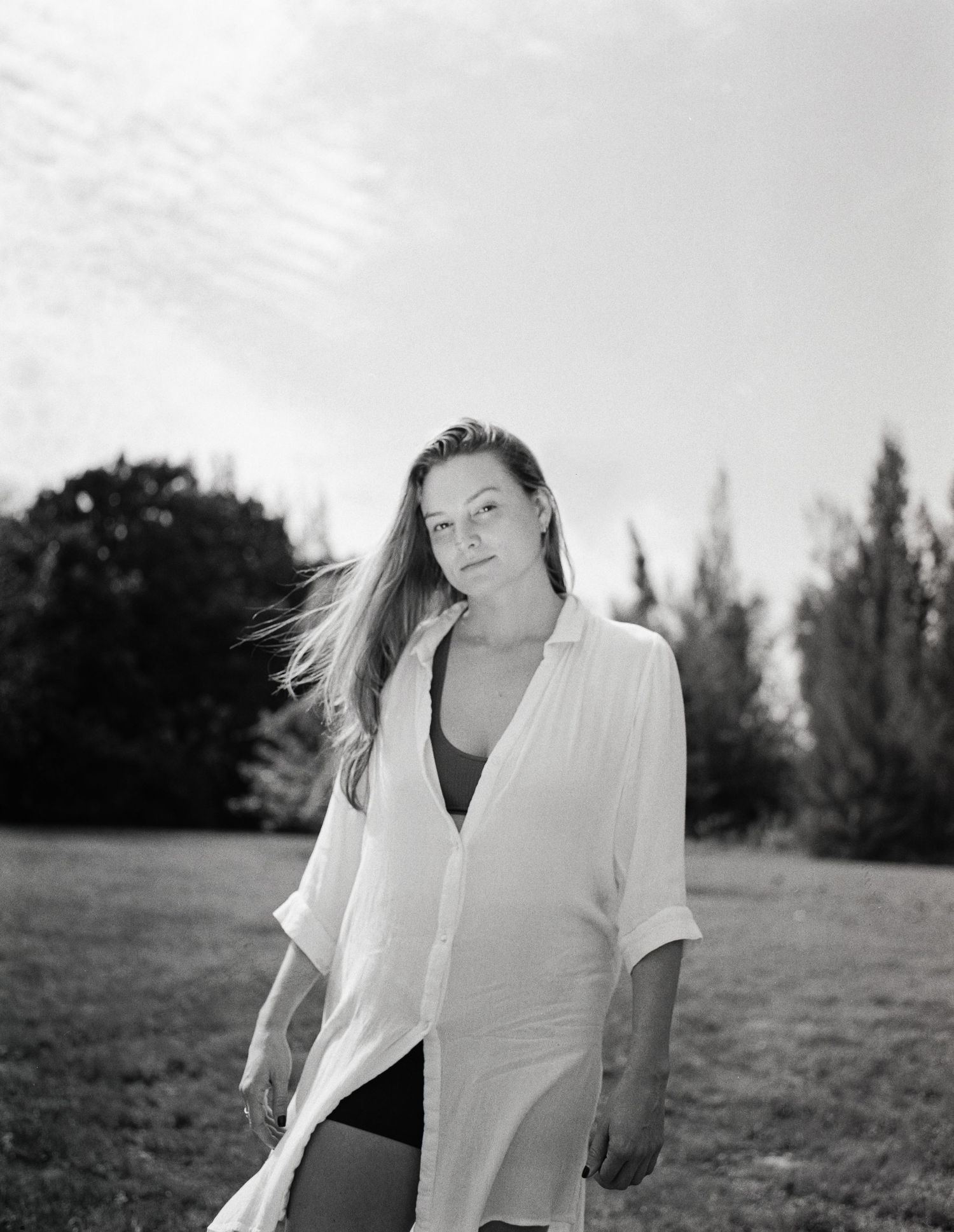 A black and white photo sequence shows a figure in a white shirt moving expressively against a natural outdoor backdrop.