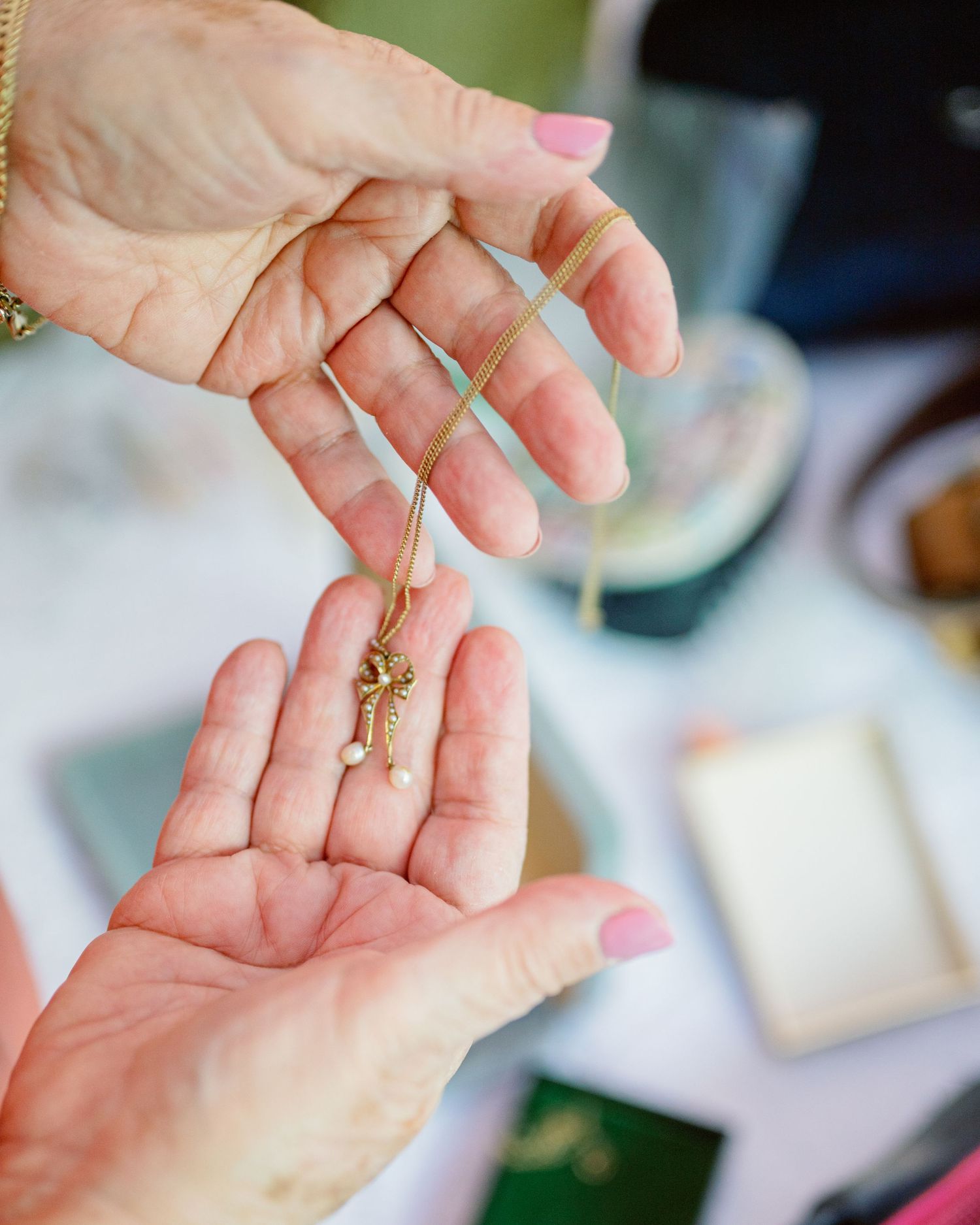 Close-up sequence of hands examining a small gold ring in natural lighting.