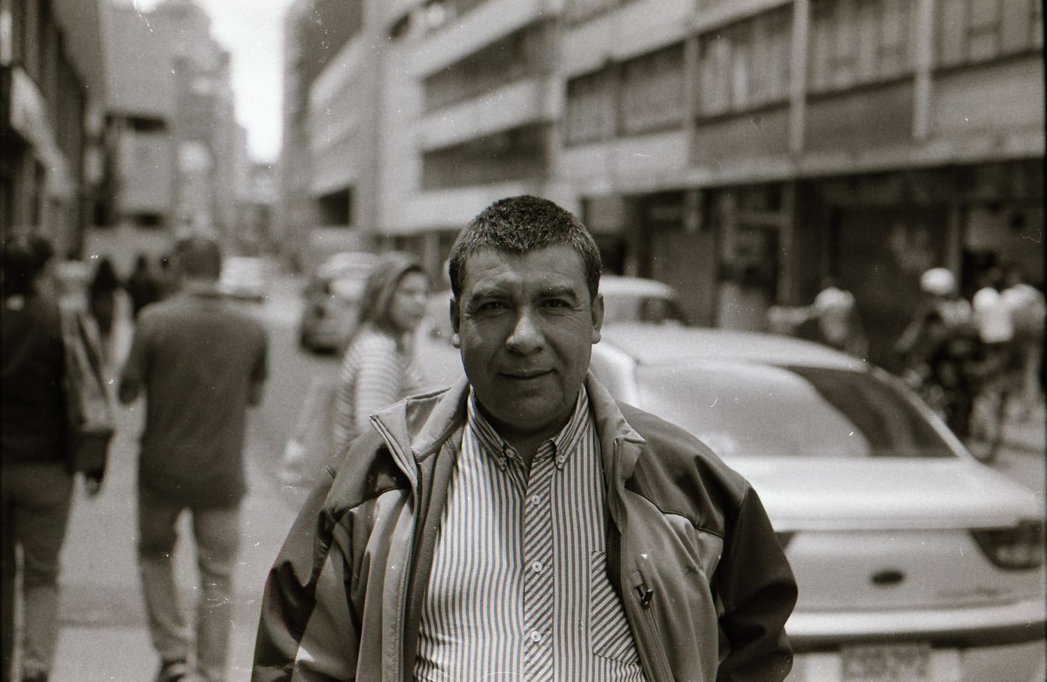 A series of vintage black and white street photographs showing urban life and pedestrians in a city setting.