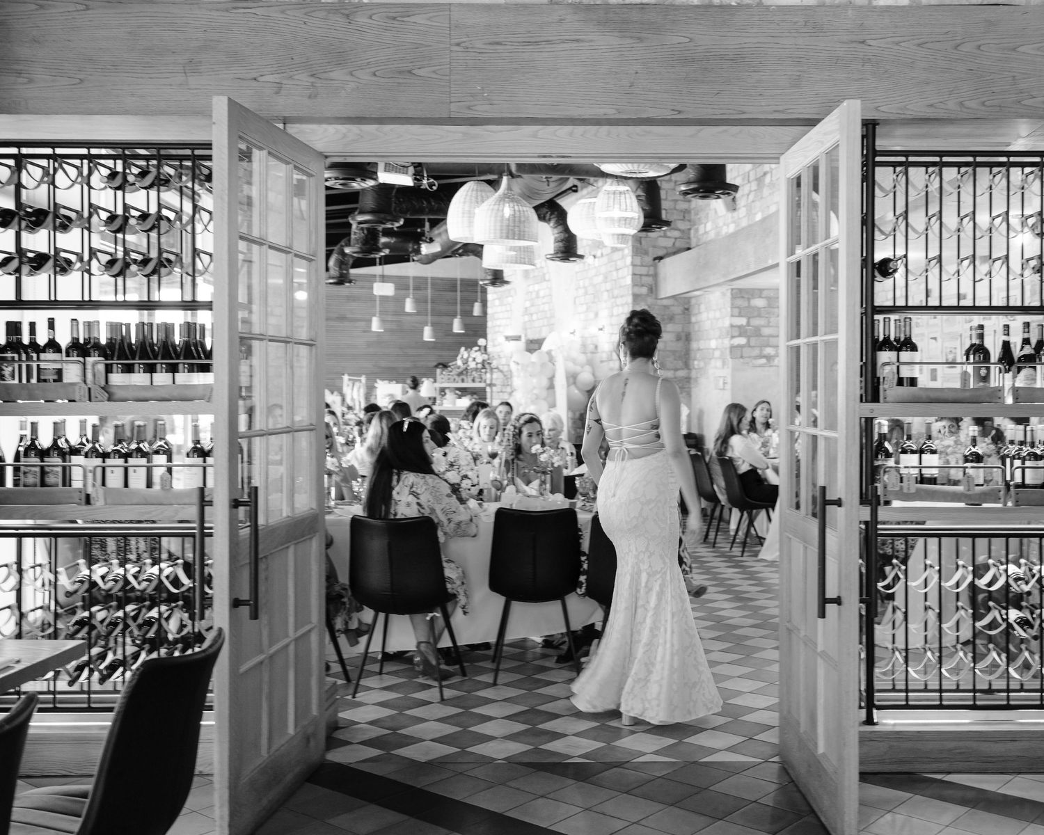 A black and white wedding photo collage showing reception venue details and guests dancing at an elegant celebration.